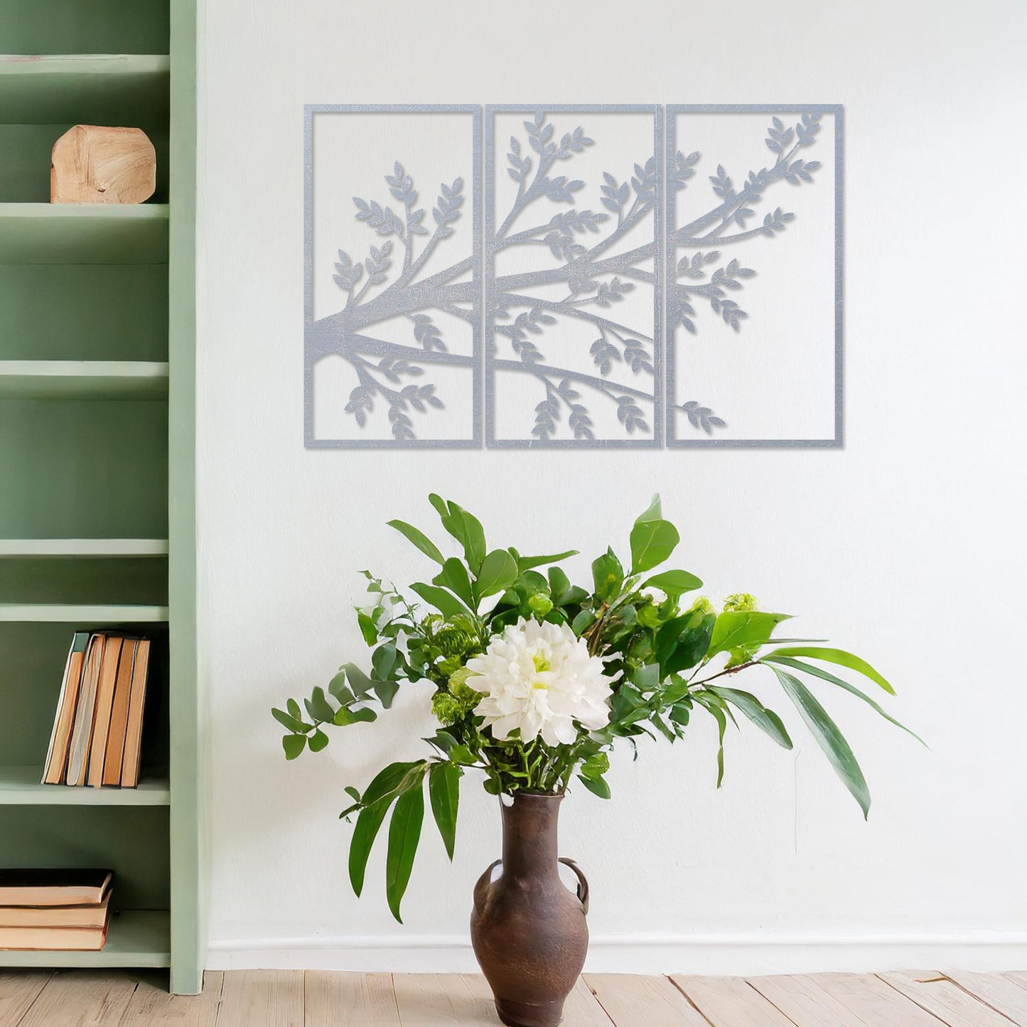 Wooden wall art featuring a three-panel design of a branching tree with delicate leaves extending gracefully across each panel. Mounted on a neutral wall within modern decor, this piece evokes a sense of natural elegance and harmony.