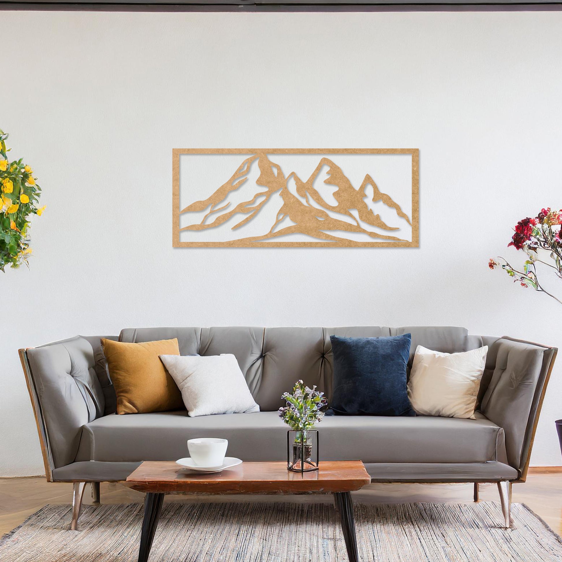 Wooden wall art featuring a stunning mountain range design, capturing the essence of natural landscapes. Set against a neutral wall in a modern decor setting, this artwork adds depth and serenity to the room's atmosphere.