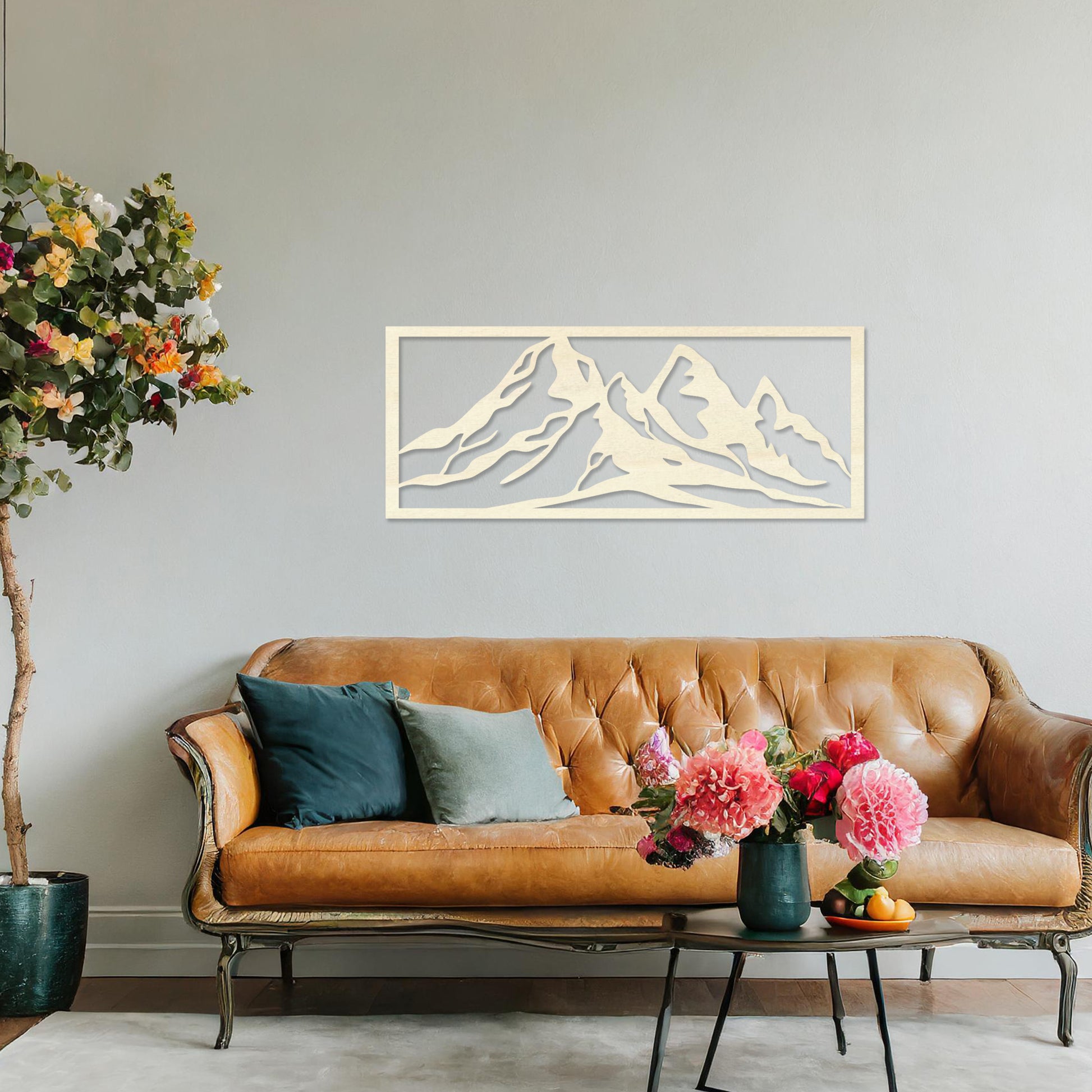 Wooden wall art featuring a stunning mountain range design, capturing the essence of natural landscapes. Set against a neutral wall in a modern decor setting, this artwork adds depth and serenity to the room's atmosphere.