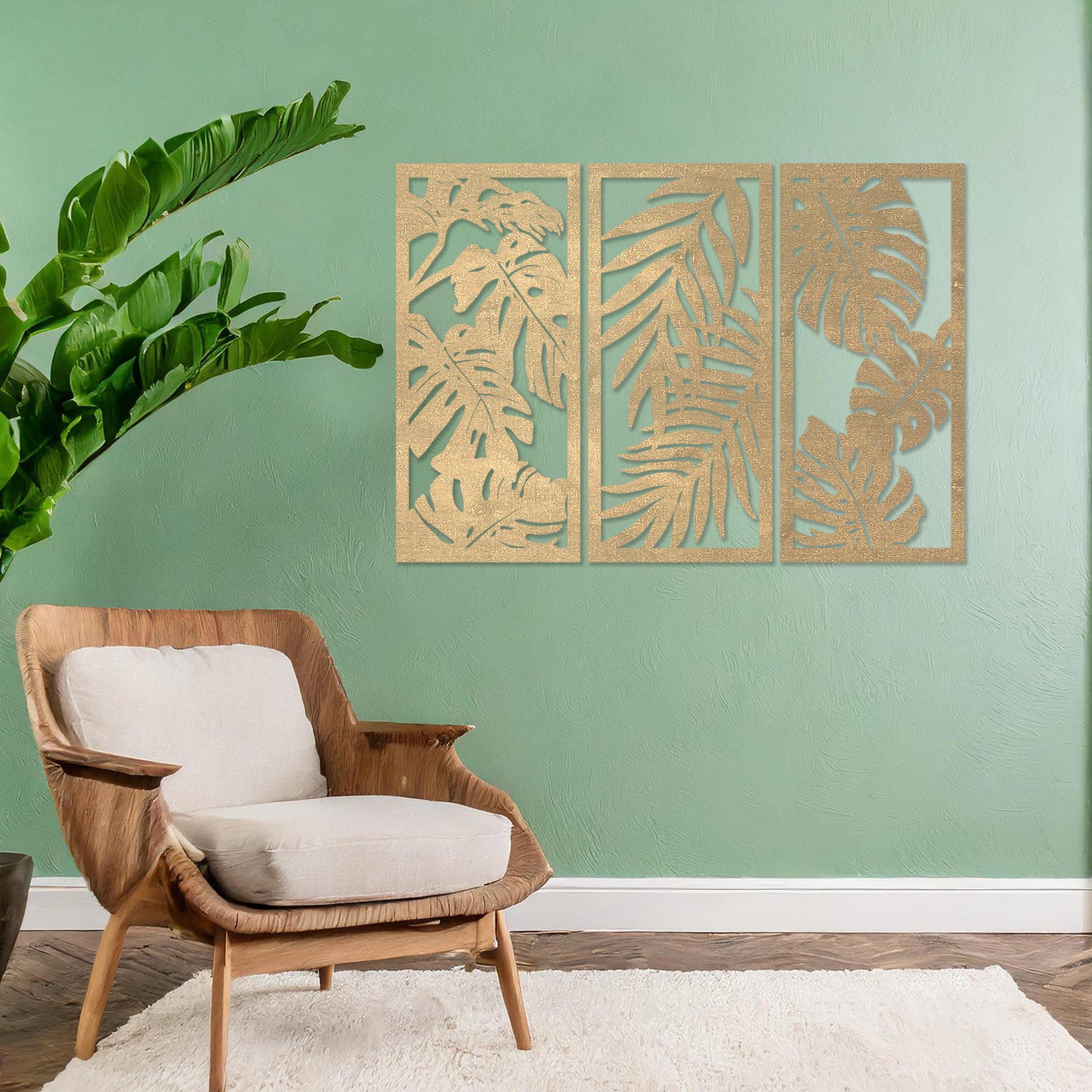 A set of three wooden wall panels featuring intricate tropical leaf designs, creating a cohesive and elegant decorative piece. Displayed on a neutral wall within modern room decor, this artwork brings a touch of nature indoors.