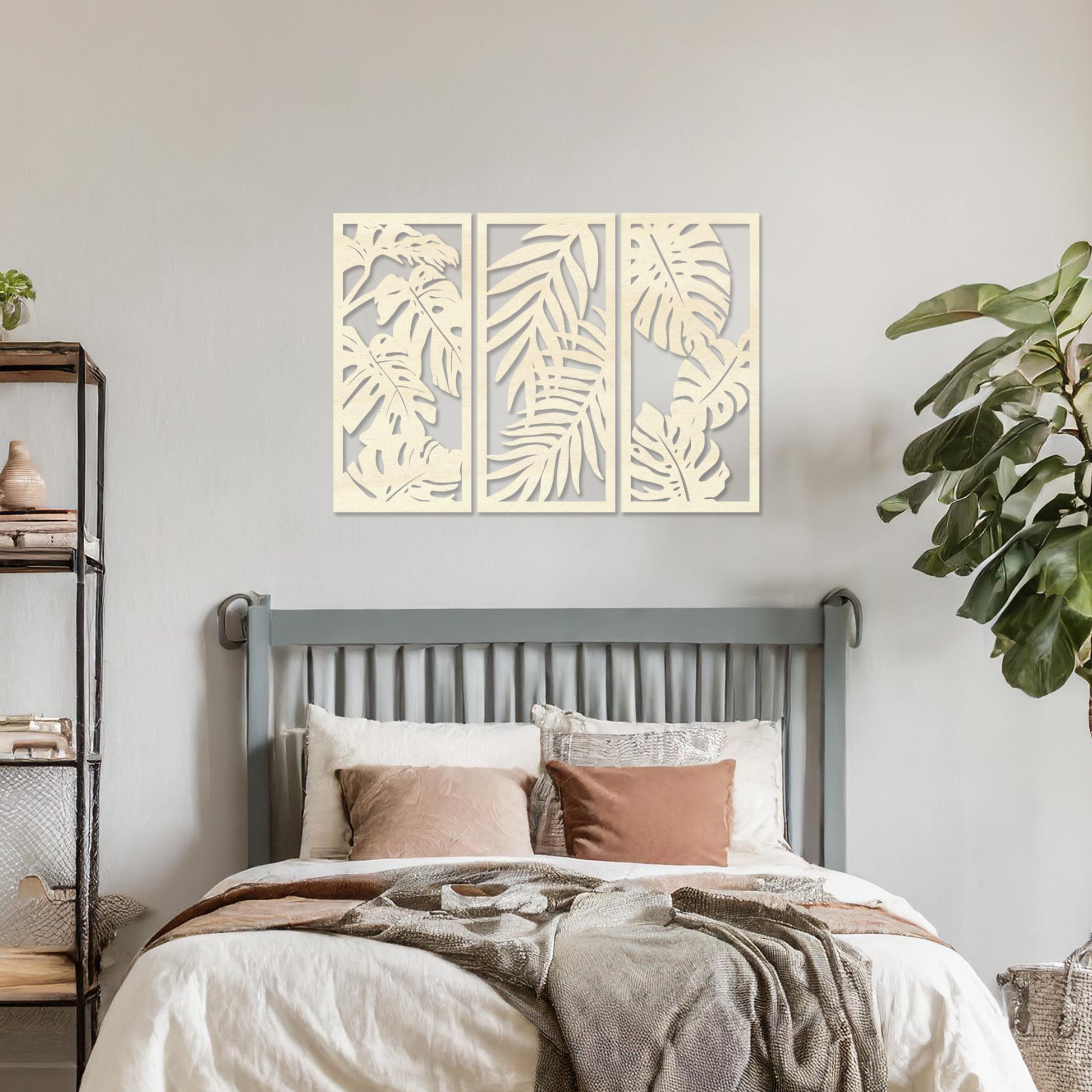 A set of three wooden wall panels featuring intricate tropical leaf designs, creating a cohesive and elegant decorative piece. Displayed on a neutral wall within modern room decor, this artwork brings a touch of nature indoors.