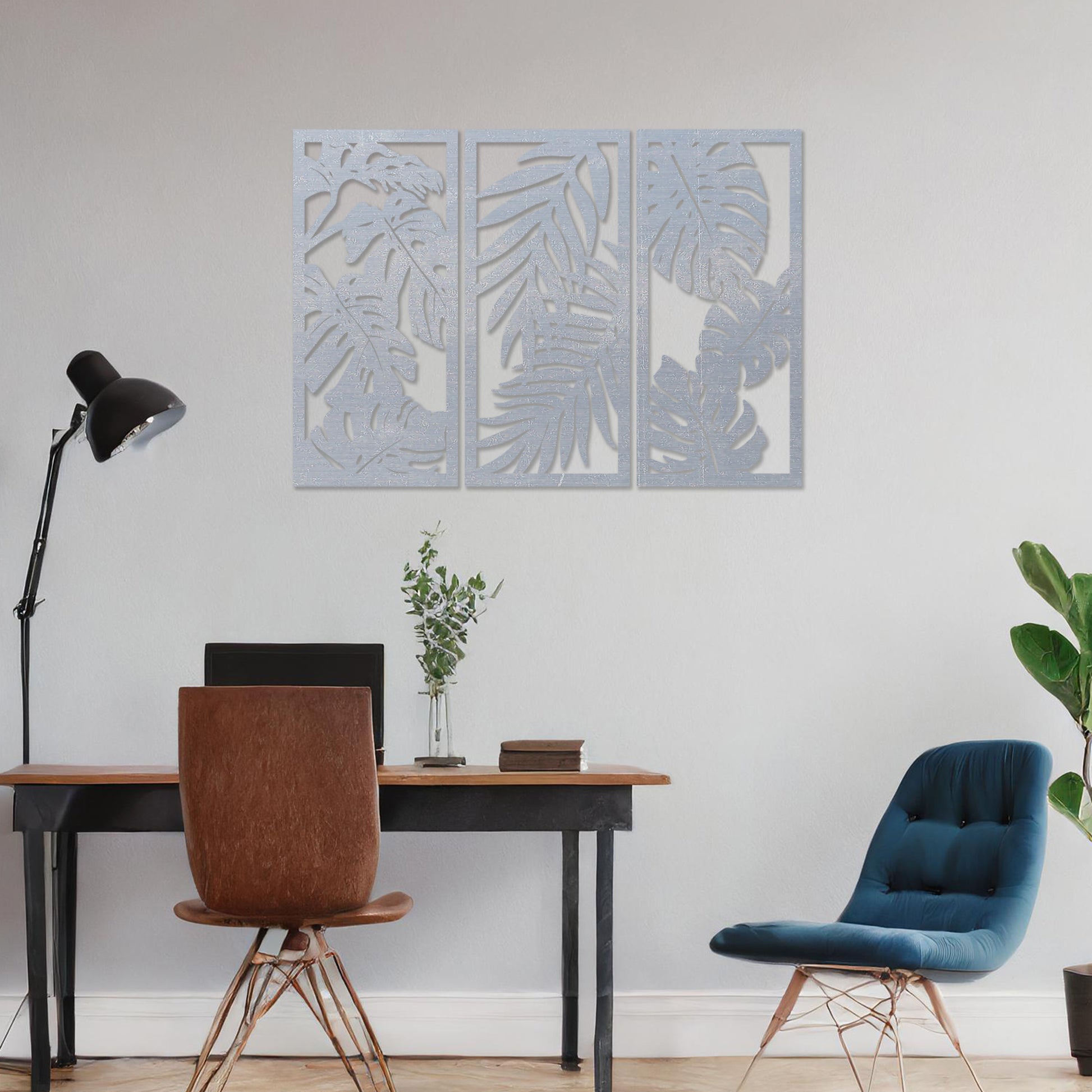 A set of three wooden wall panels featuring intricate tropical leaf designs, creating a cohesive and elegant decorative piece. Displayed on a neutral wall within modern room decor, this artwork brings a touch of nature indoors.