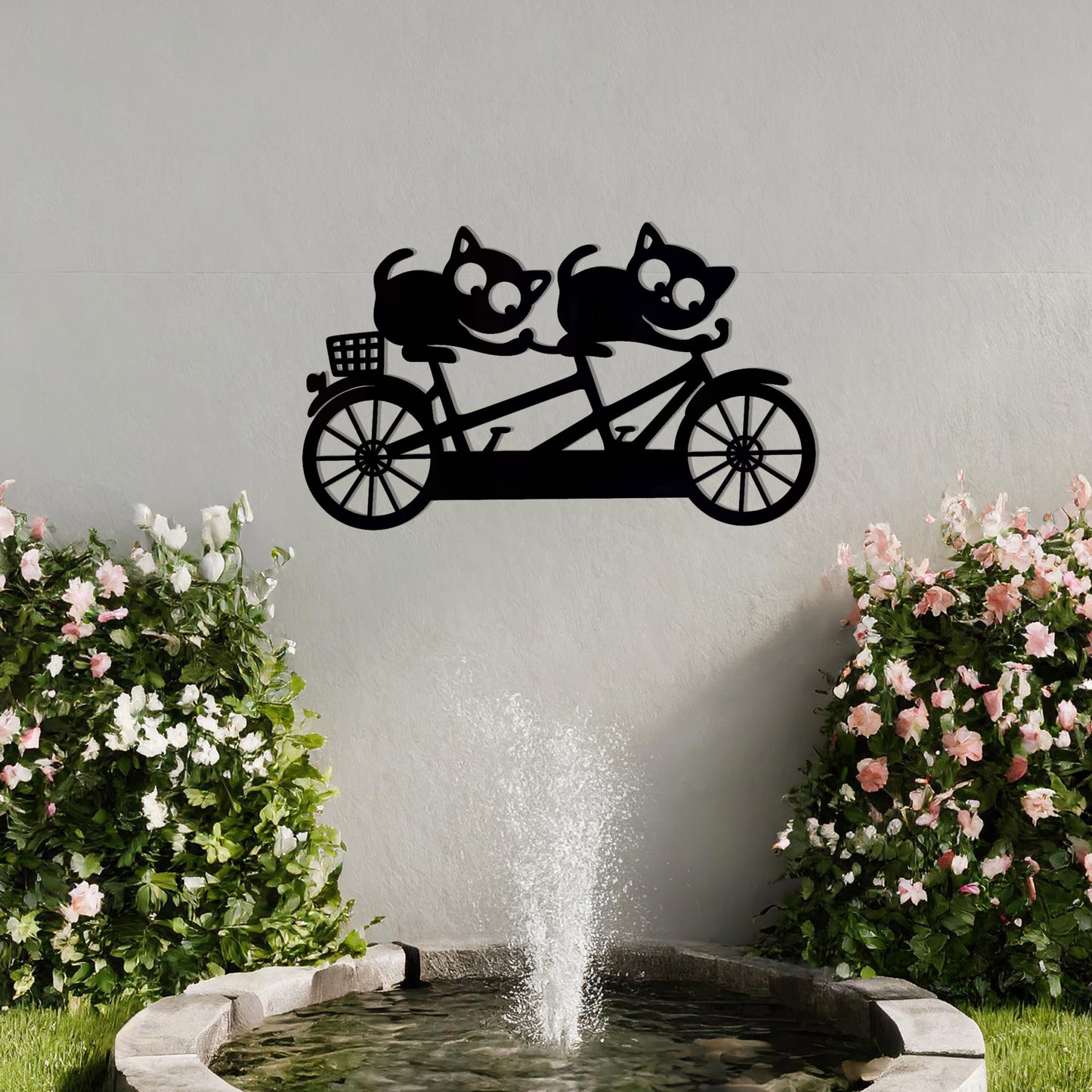 A charming metal wall art design depicting two playful cats riding a tandem bicycle, capturing a whimsical and fun moment with intricate details of the bike and expressive cat figures.
