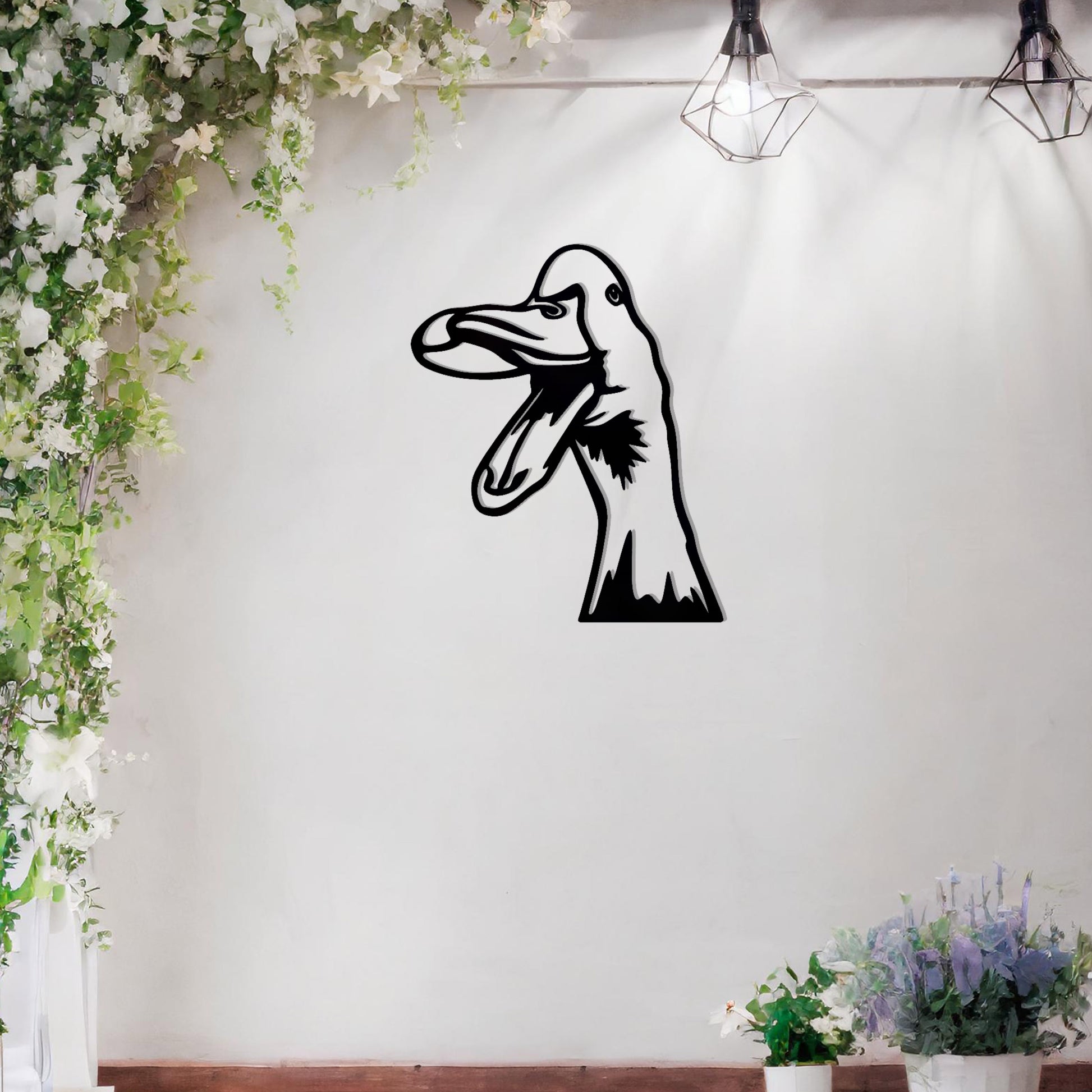 A quirky metal wall art of a duck with an open beak, showcasing playful and artistic detail. This unique design adds a touch of humor and charm to any modern setting, surrounded by greenery and soft floral accents.