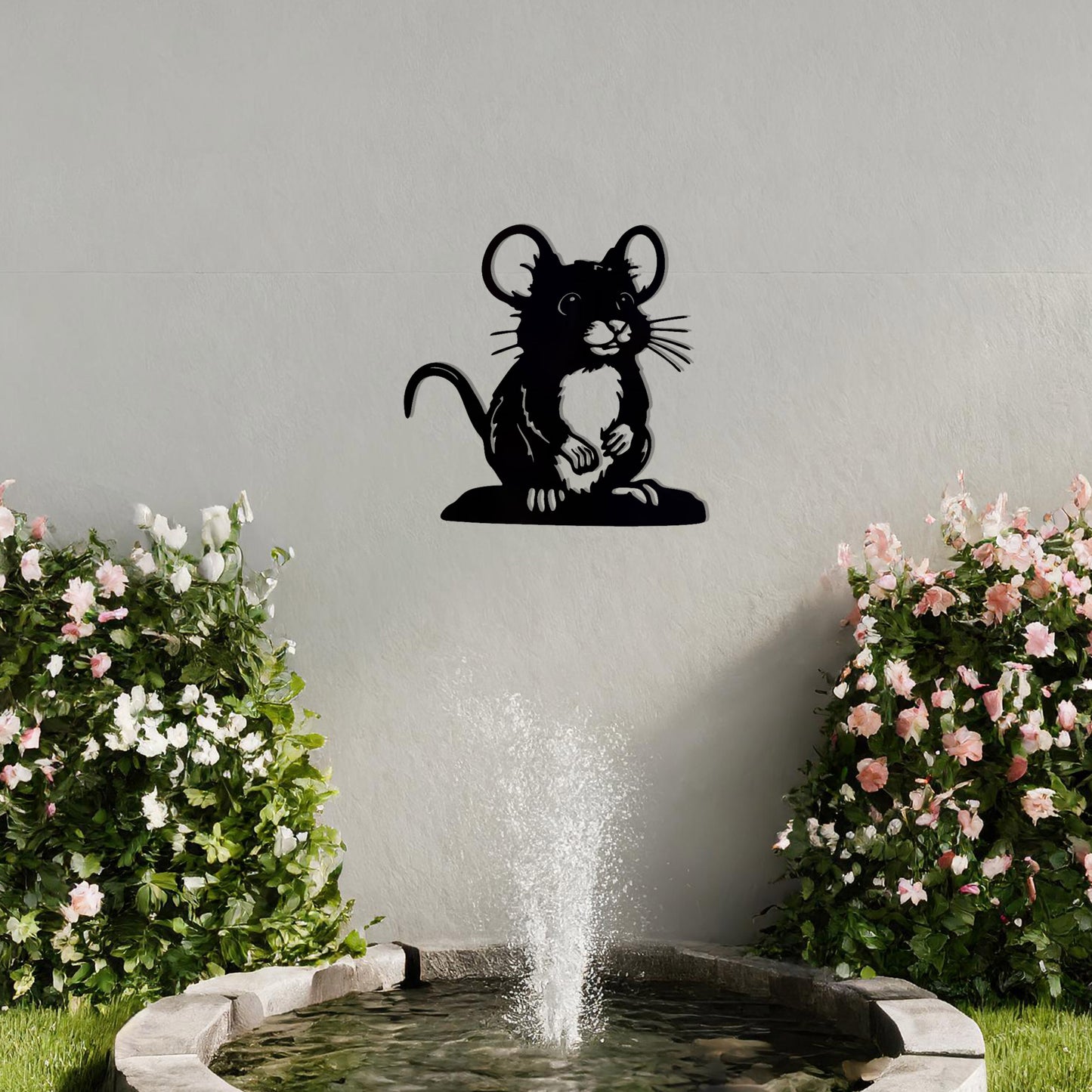 A delightful metal wall art piece featuring a whimsical mouse perched on a platform, adding a playful charm to a neutral wall. Perfect for modern garden decor, this design blends seamlessly with lush greenery and an outdoor water feature.