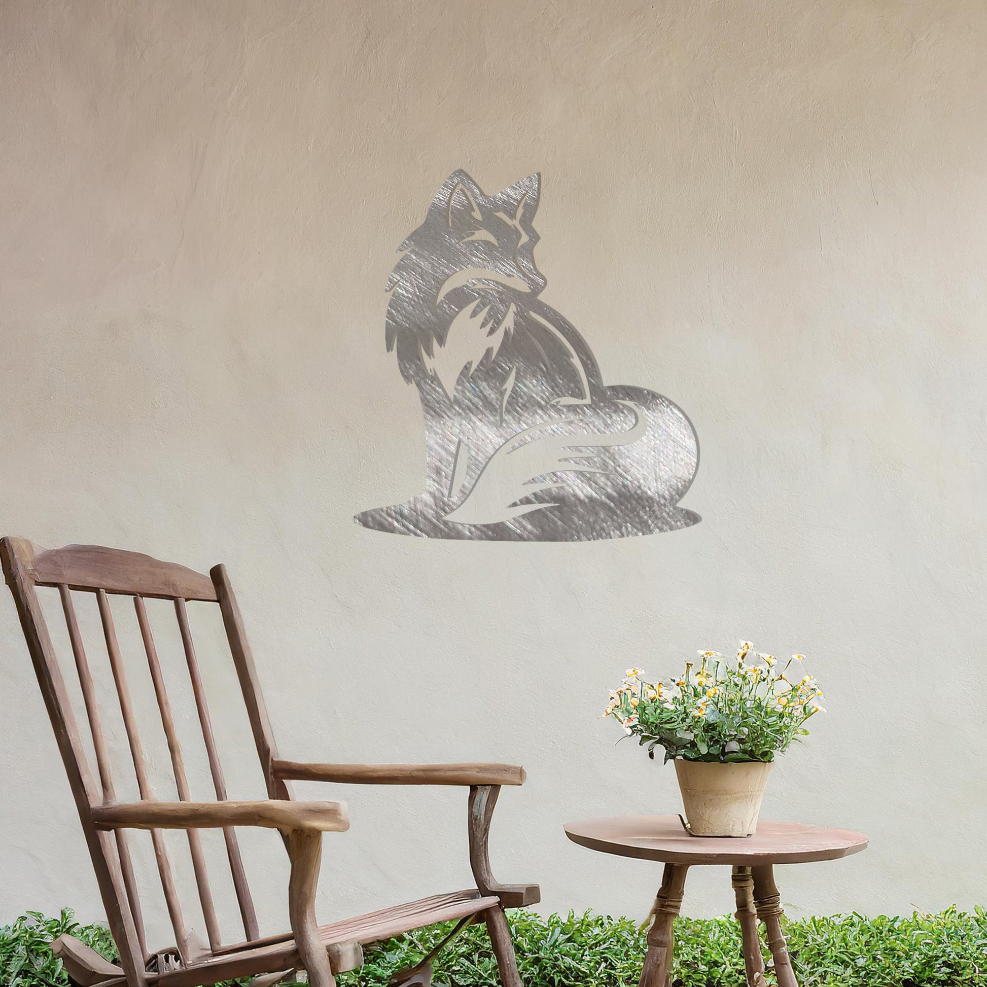 This metal wall art design depicts a sitting fox, elegantly turned to the side, showcasing its bushy tail and graceful silhouette. The minimalist yet detailed cutout enhances the fox's serene and poised demeanor, adding a touch of sophistication to any space.