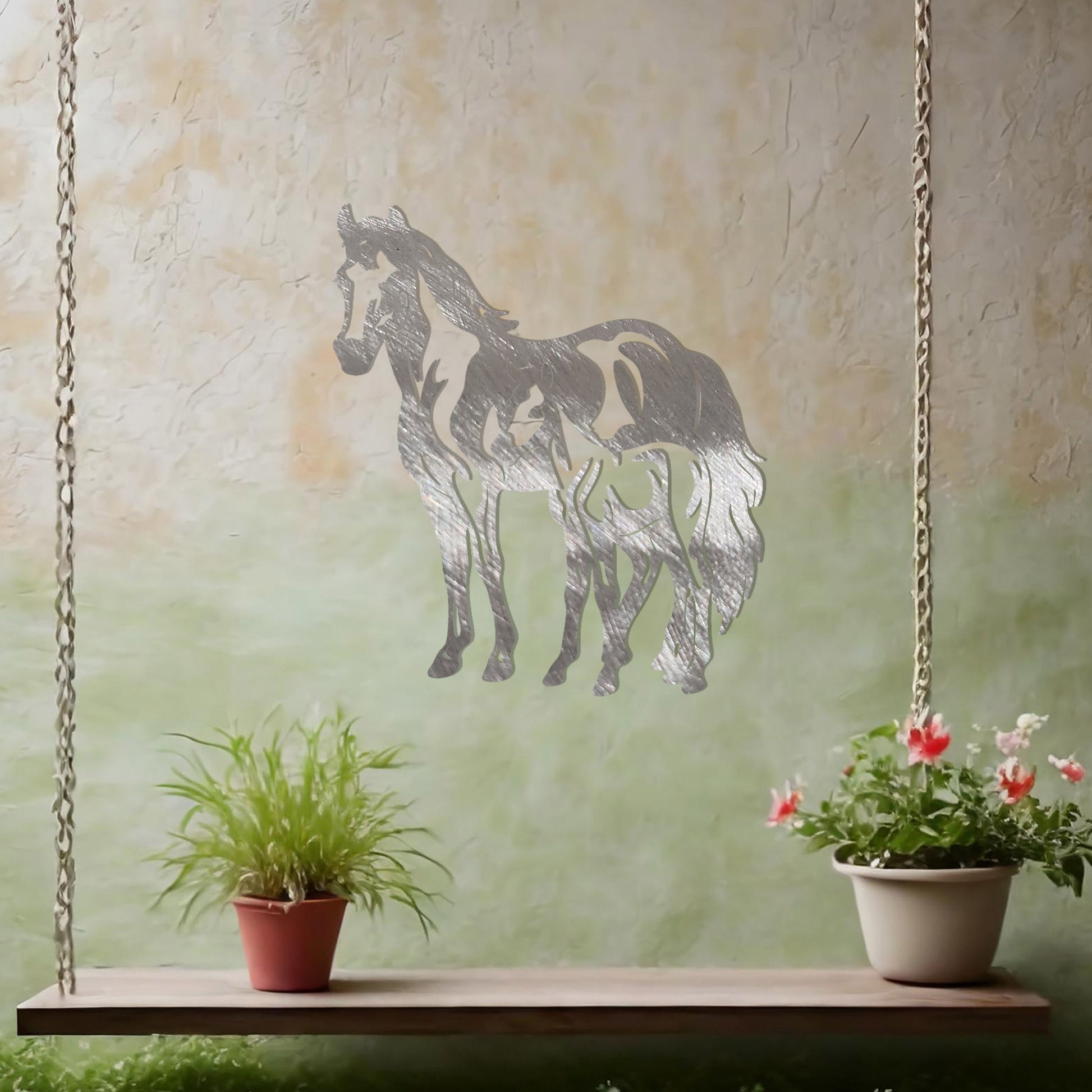 A stunning metal wall art design featuring two horses, showcasing a larger horse and a smaller one standing together, symbolising grace and unity. This artwork adds an elegant touch to a neutral wall in a beautifully styled outdoor space.