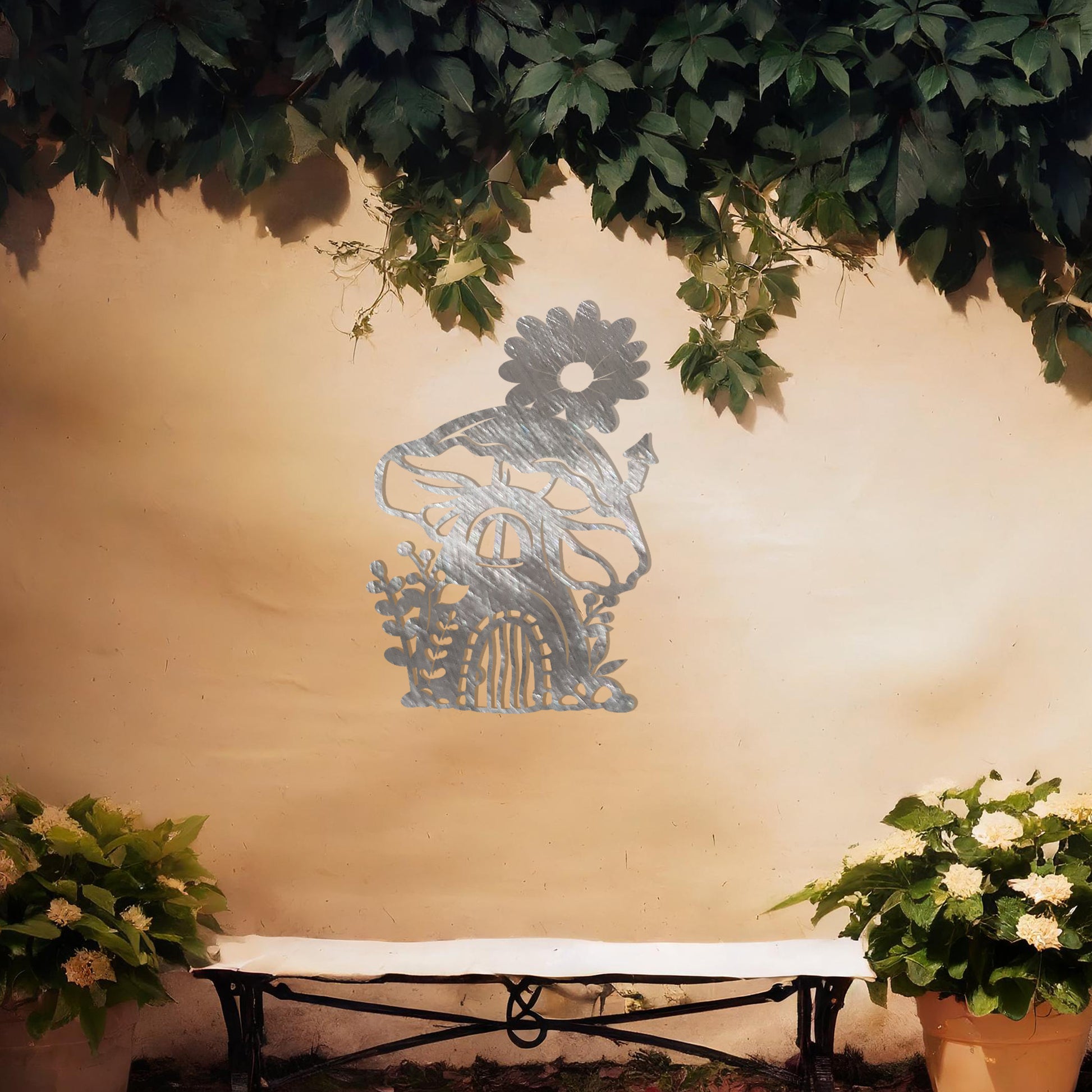 This piece depicts a whimsical mushroom house with a flower on top, surrounded by plants. Its enchanting design, perfect for garden or indoor decor, adds charm to any space with its delightful details.