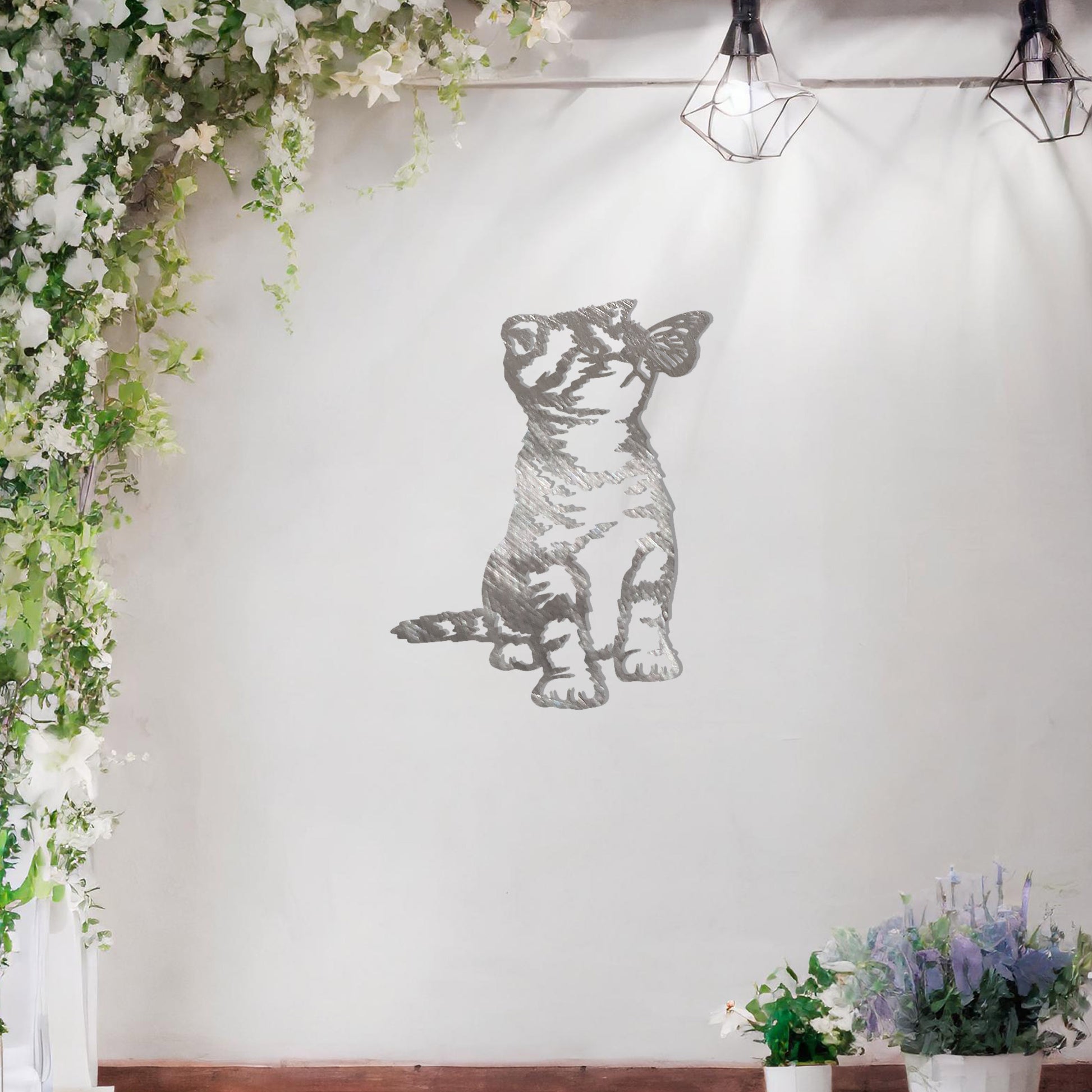 This image shows a playful and endearing design of a kitten interacting with a butterfly. The cat, in a curious and playful pose, captures the essence of feline innocence and charm. It’s a delightful piece of wall art that would add a whimsical touch to any space.