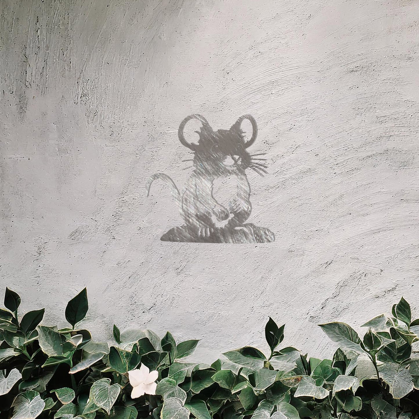A delightful metal wall art piece featuring a whimsical mouse perched on a platform, adding a playful charm to a neutral wall. Perfect for modern garden decor, this design blends seamlessly with lush greenery and an outdoor water feature.