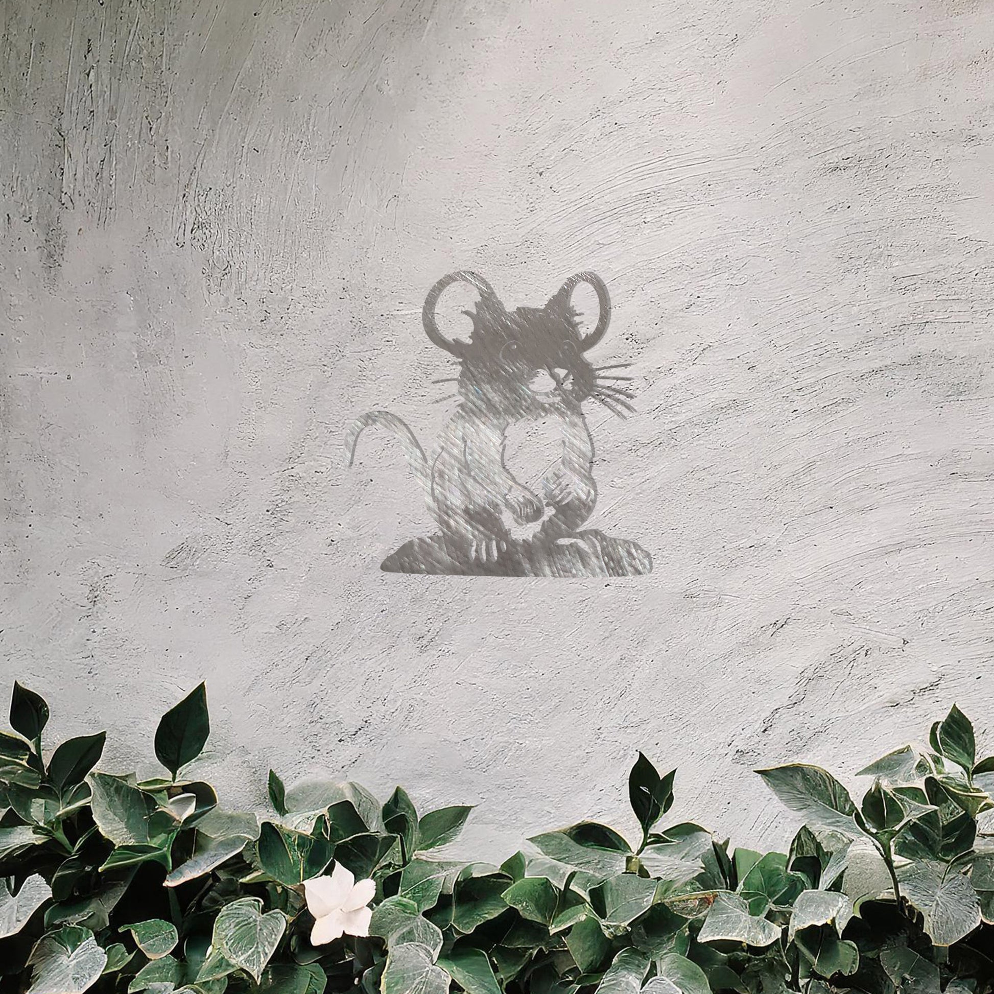 A delightful metal wall art piece featuring a whimsical mouse perched on a platform, adding a playful charm to a neutral wall. Perfect for modern garden decor, this design blends seamlessly with lush greenery and an outdoor water feature.
