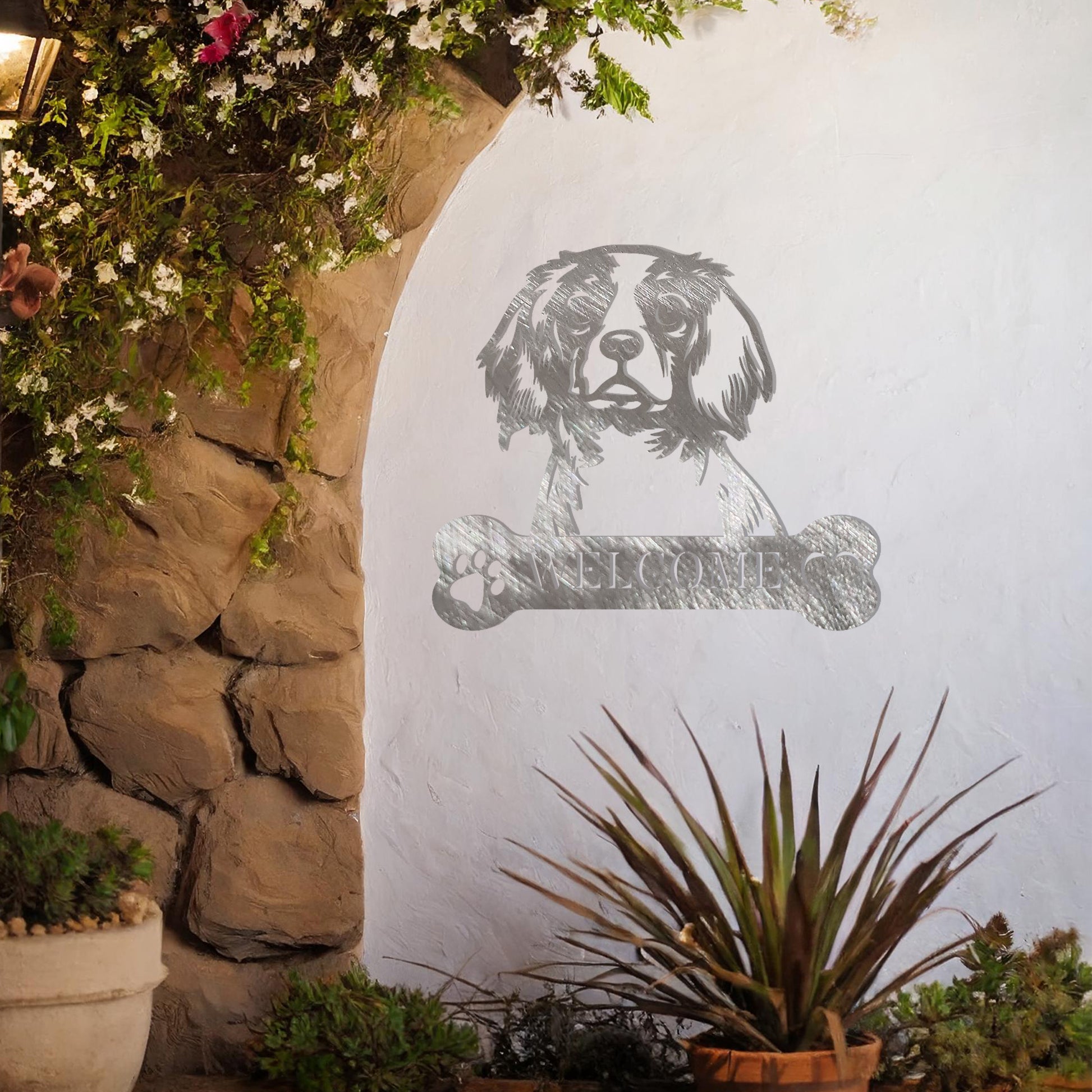 Metal Cavalier King Charles Spaniel dog design with a bone-shaped 'WELCOME' text and paw prints, perfect for adding a charming and welcoming touch to entryways or outdoor spaces.