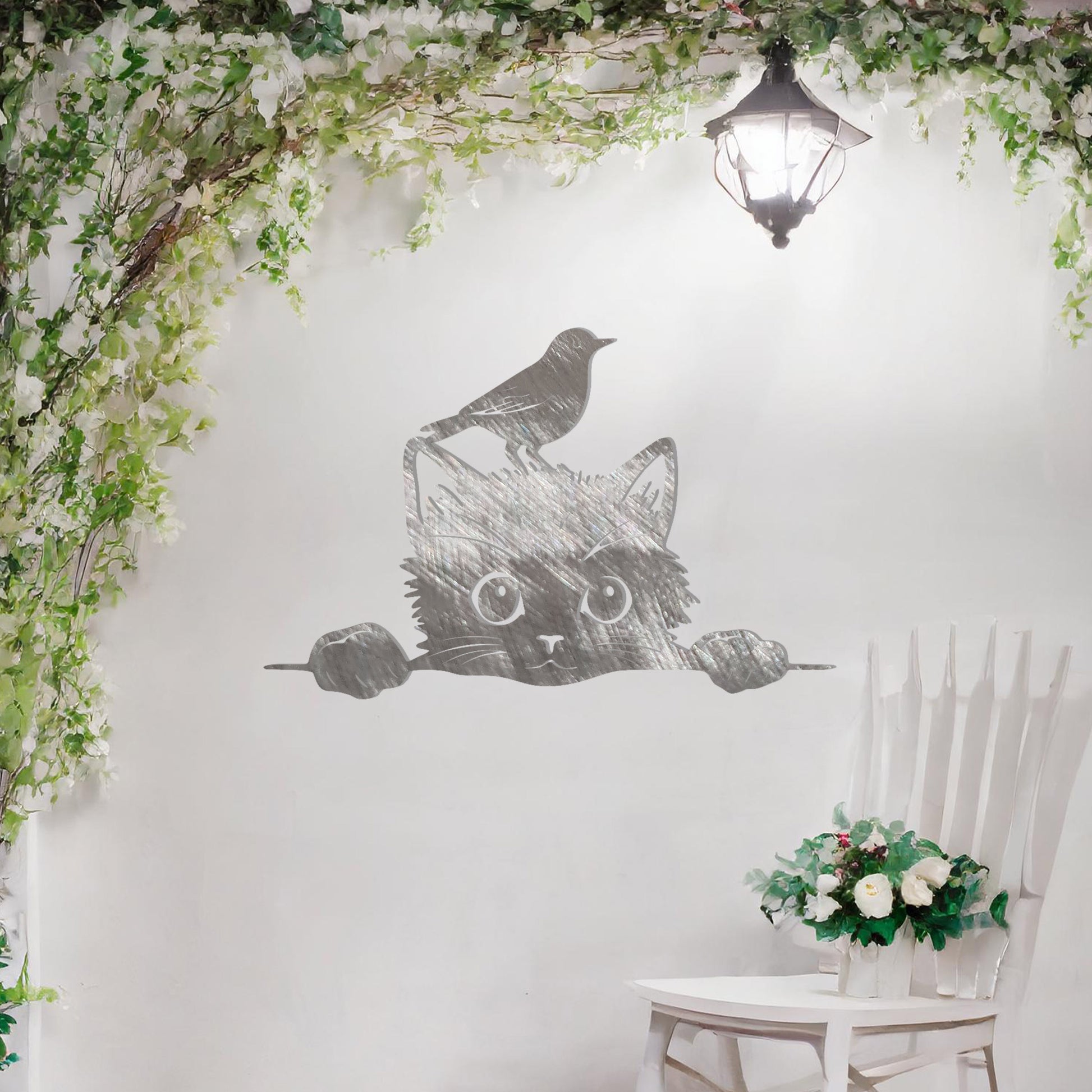 This is a charming and playful metal wall art design featuring a curious cat peeking over a fence, with a bird sitting atop its head. It brings a whimsical and fun element to any space, perfect for animal lovers and nature-themed decor.