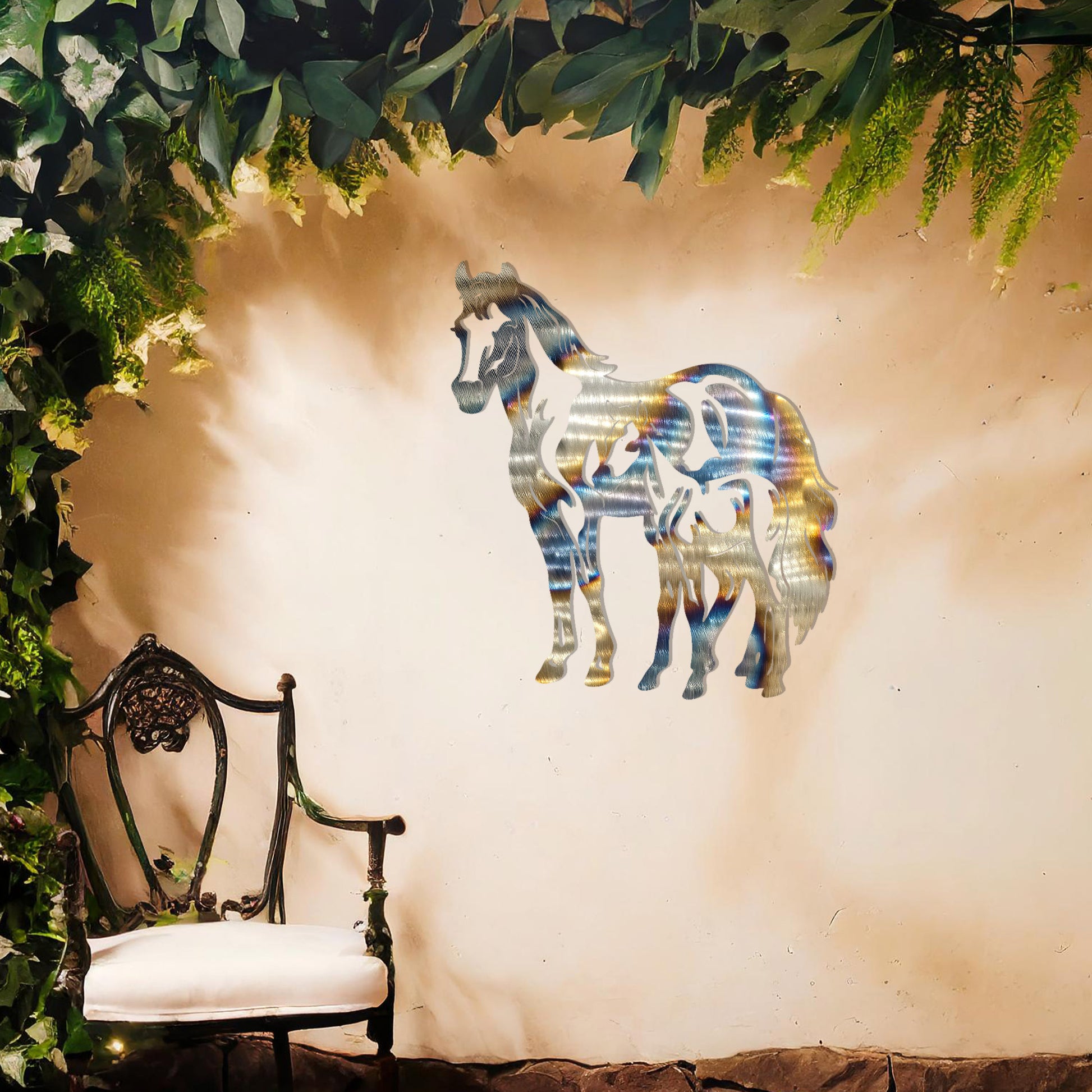 A stunning metal wall art design featuring two horses, showcasing a larger horse and a smaller one standing together, symbolising grace and unity. This artwork adds an elegant touch to a neutral wall in a beautifully styled outdoor space.