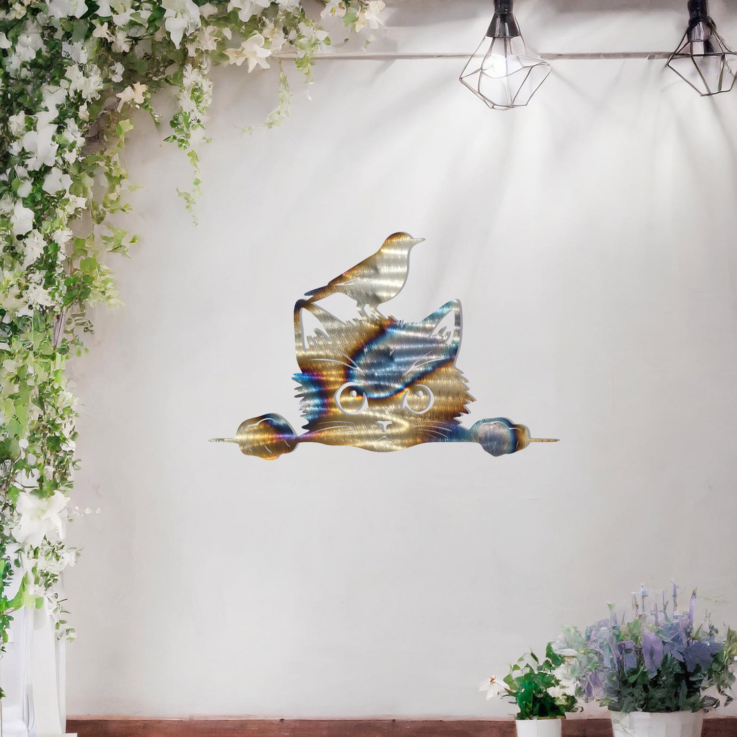 This is a charming and playful metal wall art design featuring a curious cat peeking over a fence, with a bird sitting atop its head. It brings a whimsical and fun element to any space, perfect for animal lovers and nature-themed decor.