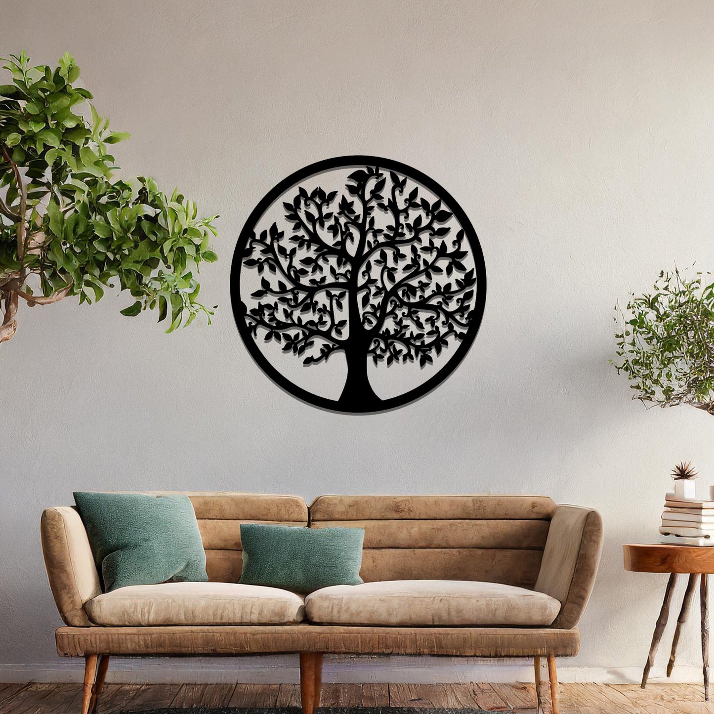 Metal wall art featuring a circular design with a detailed tree of life motif, showcasing intricate branches and leaves, mounted on a neutral wall within modern room decor. The elegant craftsmanship and symbolic design add a touch of sophistication and meaning to the space.