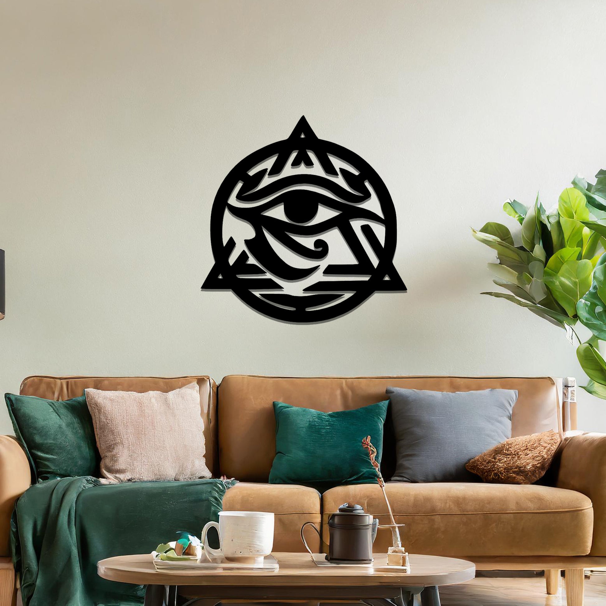 Metal wall art featuring an intricate design of the Eye of Horus, enclosed within a geometric triangle and circle. The artwork is placed on a neutral wall in a modern living room setting, adding to the contemporary decor.