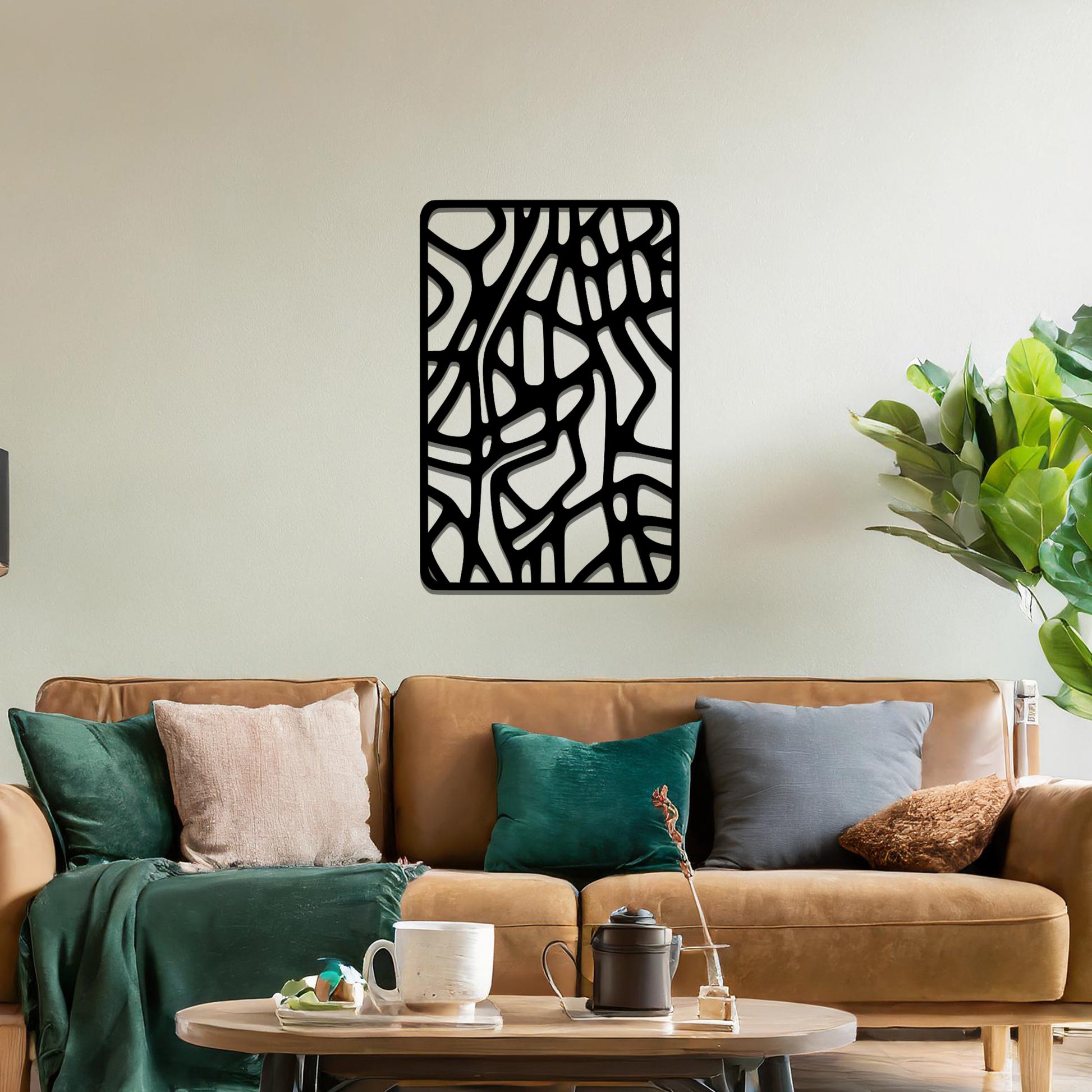 Metal wall art featuring an abstract design with interconnected lines and shapes, creating an organic pattern. The art is placed on a neutral wall within modern living room decor, enhancing the contemporary style of the space.