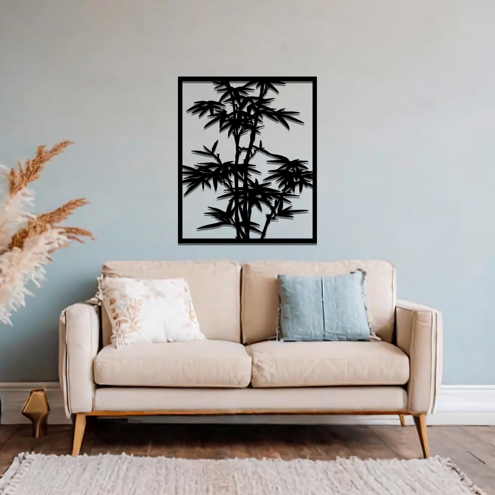 Metal wall art featuring a rectangular design of bamboo stalks with detailed leaves, creating an elegant and nature-inspired accent for the living space.