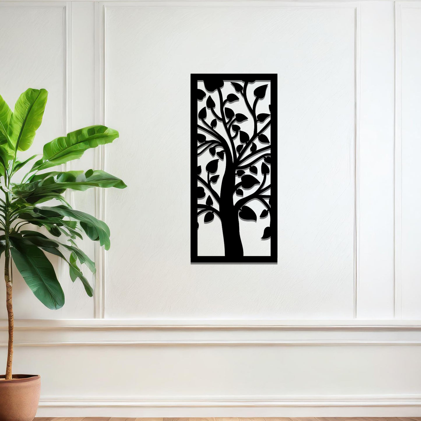 Metal wall art featuring a rectangular design with a stylised tree motif, showcasing flowing branches and leaves, mounted on a neutral wall within modern room decor. The minimalist craftsmanship adds a sleek and natural aesthetic, enhancing the contemporary elegance of the space.