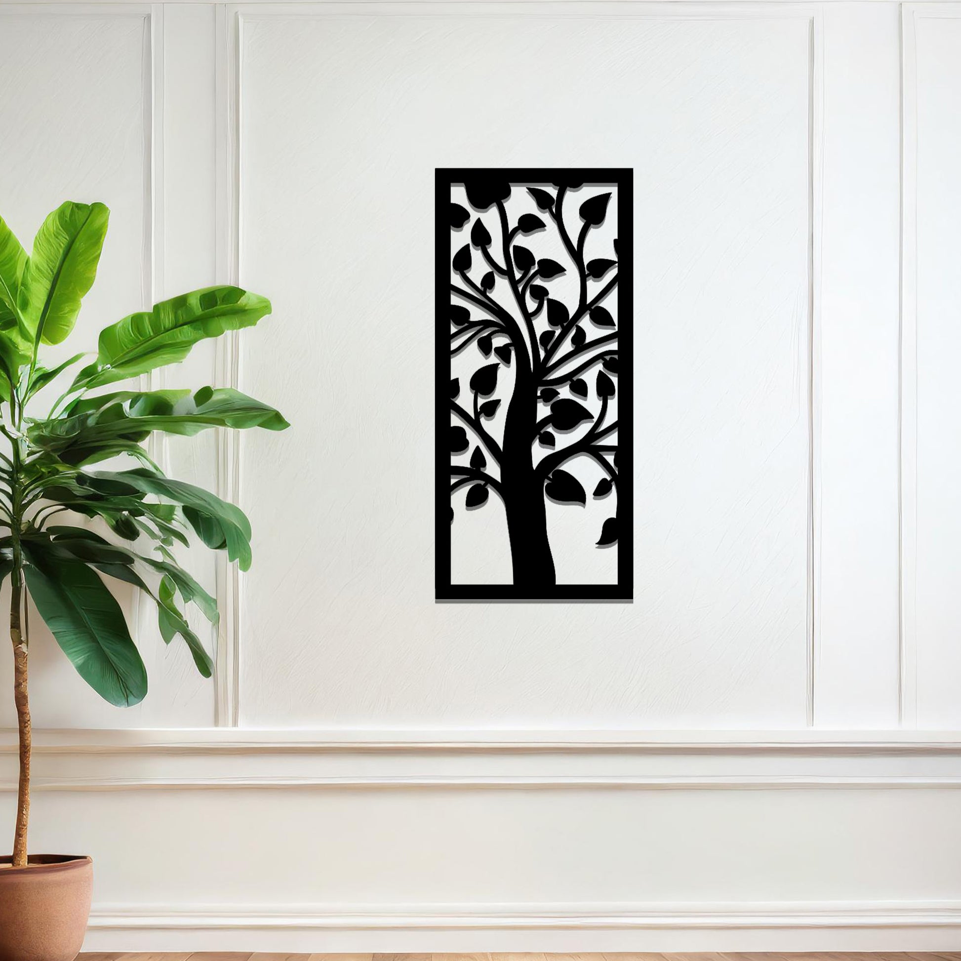 Metal wall art featuring a rectangular design with a stylised tree motif, showcasing flowing branches and leaves, mounted on a neutral wall within modern room decor. The minimalist craftsmanship adds a sleek and natural aesthetic, enhancing the contemporary elegance of the space.