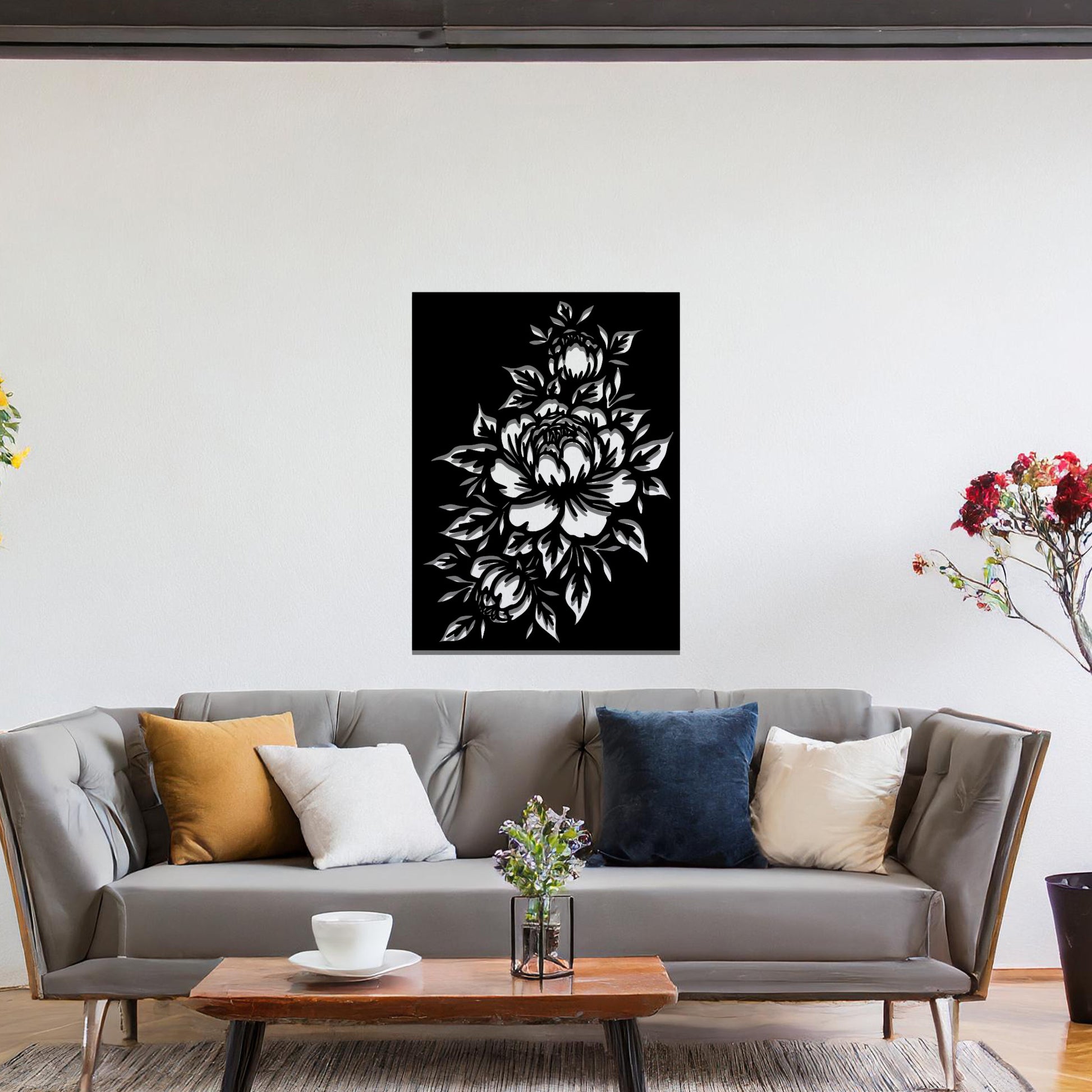 Metal wall art featuring a detailed design of a bouquet of roses, with large blossoms and intricate leaves. The design is cut-out, capturing the delicate petals and curves of the flowers. The artwork is displayed against a neutral wall within a modern interior.