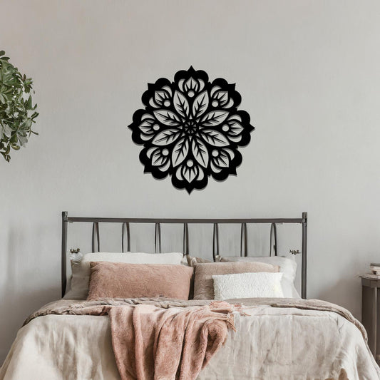 Metal wall art featuring an intricate mandala design with symmetrical floral patterns, mounted on a neutral wall within modern room decor. The detailed craftsmanship and balanced geometry create a striking focal point, enhancing the sophistication of the space.