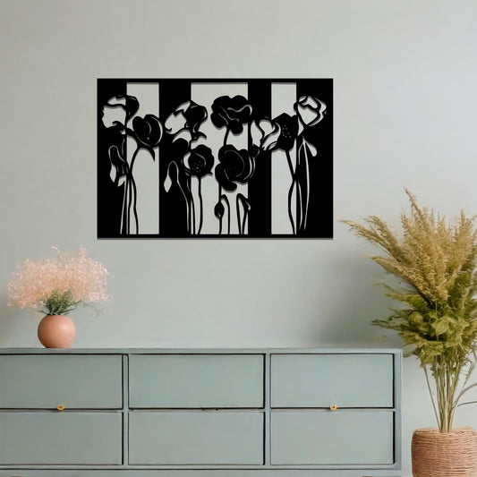 A metal wall art design featuring stylized flowers with long, elegant stems, arranged vertically in a series of three sections. The art is displayed on a neutral wall within a modern room decor, adding a contemporary and artistic touch to the space.