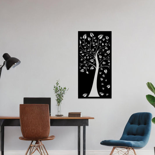 Metal wall art featuring a tree with intricate branches and leaves, enclosed in a vertical rectangular frame. The artwork is displayed on a neutral wall within a modern office setting, complemented by a desk, chair, and indoor plants.