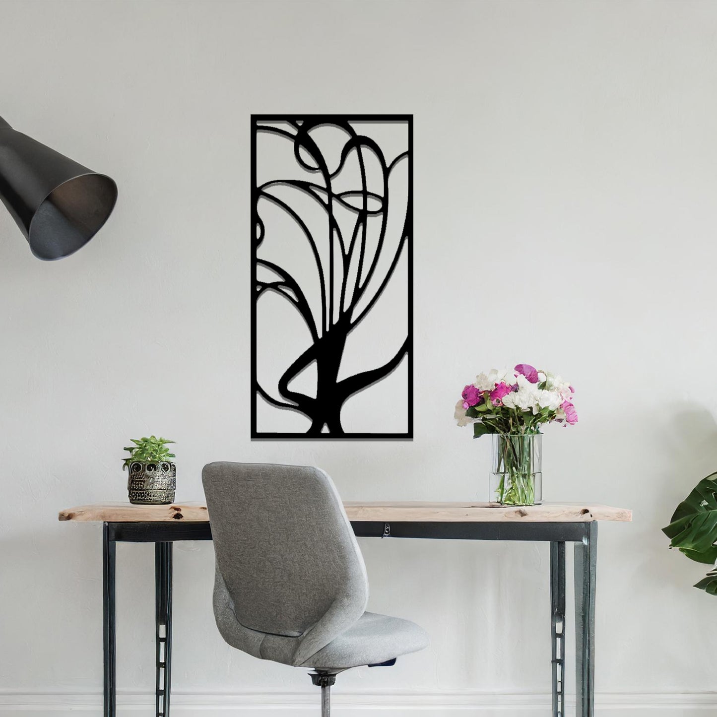 Metal wall art featuring a rectangular abstract design with flowing, interconnected lines, adding a modern and artistic element to the space.