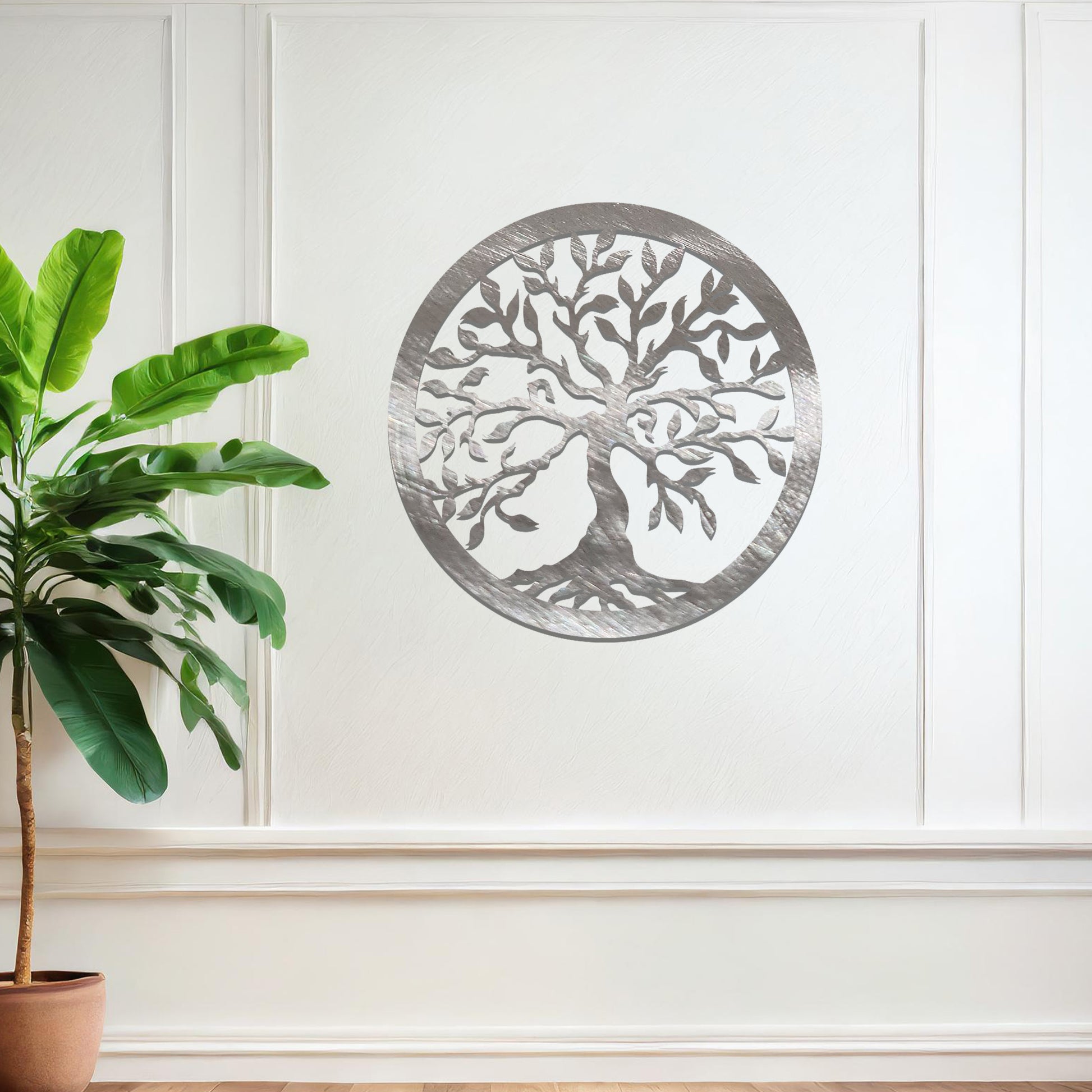 Metal wall art featuring a circular tree of life design with intricate branches and leaves, mounted on a neutral wall within modern bedroom decor. The detailed craftsmanship and symbolic motif create a calming and elegant focal point in the room.