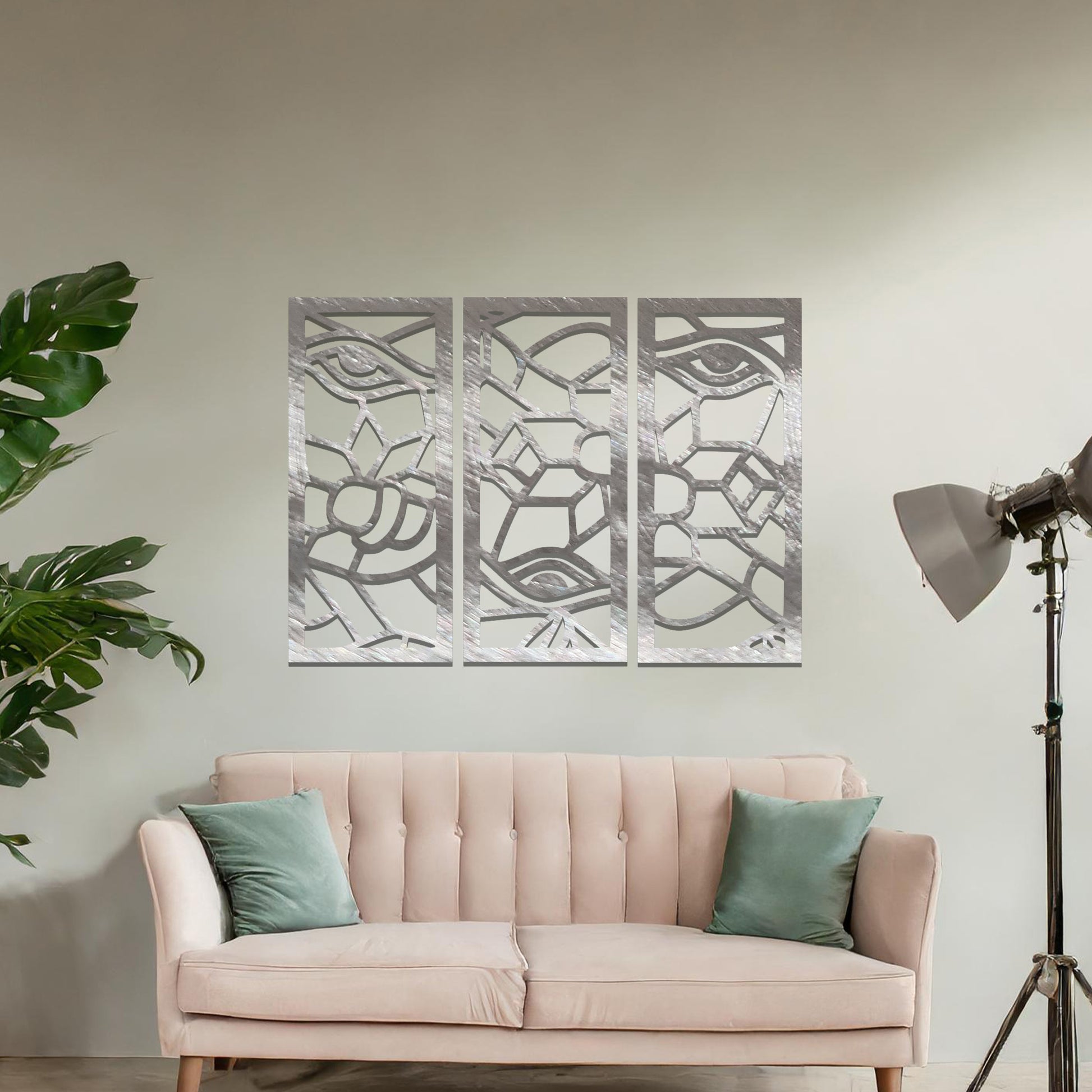 Decorative metal wall art featuring a set of three geometric panels with intricate abstract designs, mounted on a neutral wall within modern room decor. The focus is on the unique craftsmanship and harmonious composition of the wall art, enhancing the contemporary aesthetic of the space.