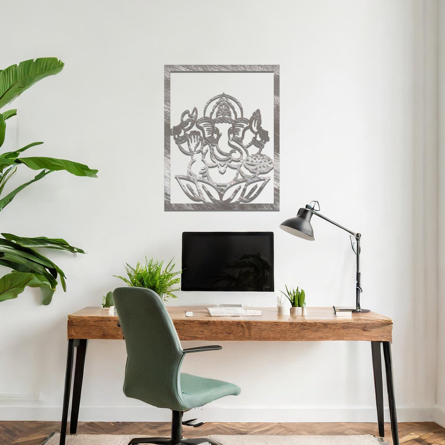 Metal wall art featuring a rectangular design of Lord Ganesha sitting on a lotus, showcasing intricate detailing of the deity's form and symbolic elements, mounted on a neutral wall within modern room decor. The craftsmanship adds a spiritual and artistic touch to the space.
