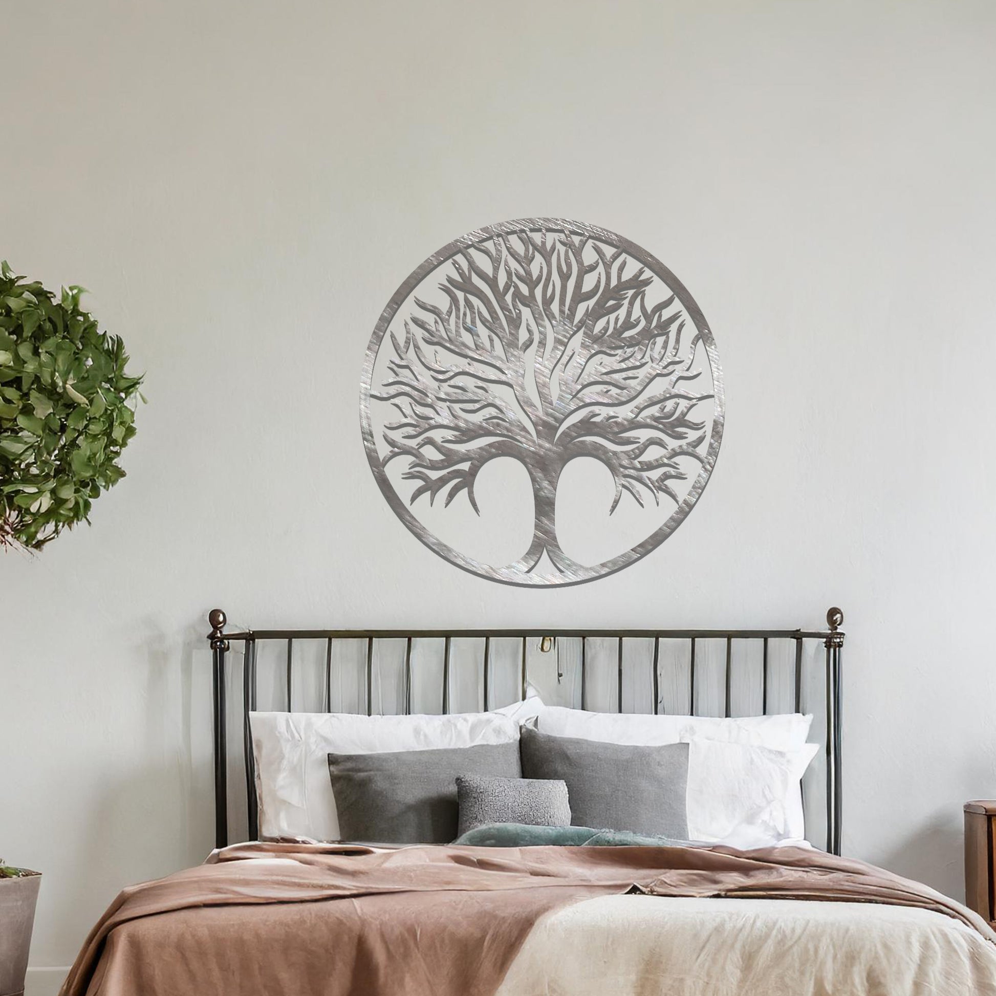 Intricate metal wall art design featuring a tree with a circular frame, highlighting its branching details for a natural and elegant look in modern decor.