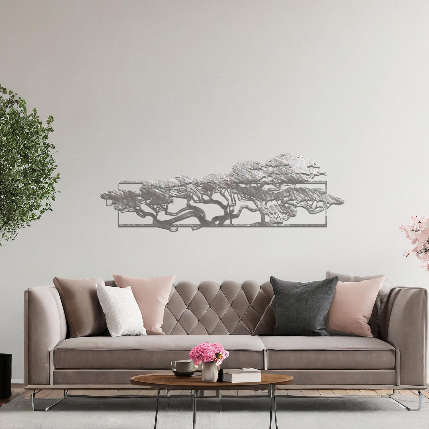 Metal wall art featuring a landscape design of a silhouette of trees with intricate branches, framed within a rectangular panel, crafted with precise laser-cut techniques, displayed on a neutral wall within modern decor.