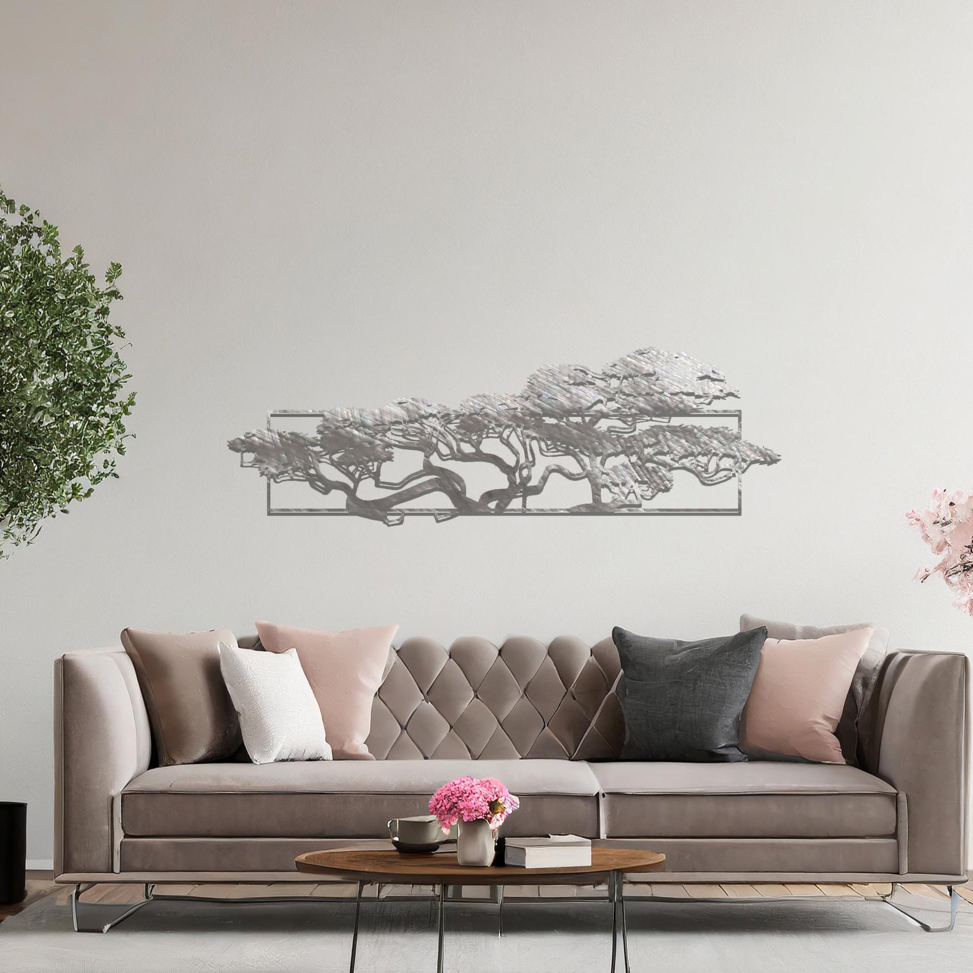 Metal wall art featuring a landscape design of a silhouette of trees with intricate branches, framed within a rectangular panel, crafted with precise laser-cut techniques, displayed on a neutral wall within modern decor.
