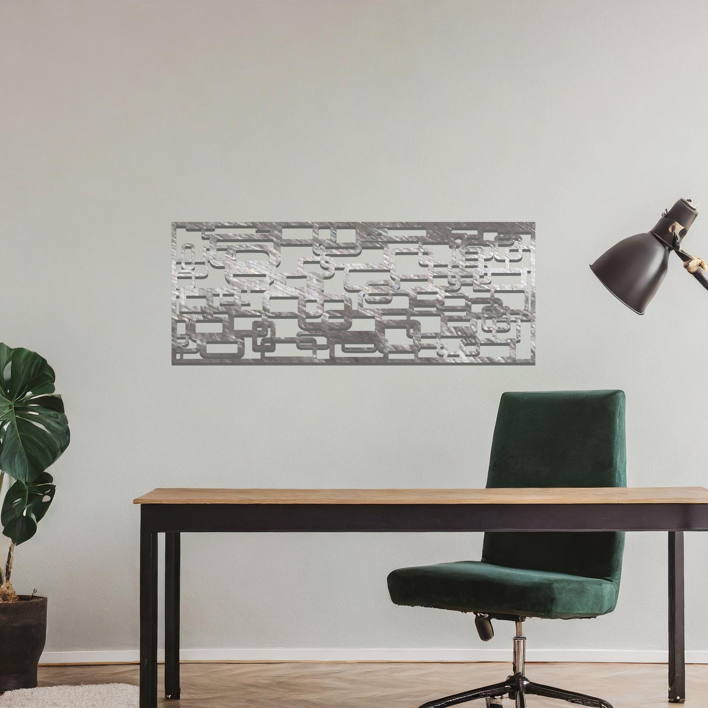 Metal wall art featuring an abstract geometric design with overlapping and interlocking rectangular shapes. The artwork is placed on a neutral wall in a modern living room, complementing contemporary decor with its dynamic and stylish form.