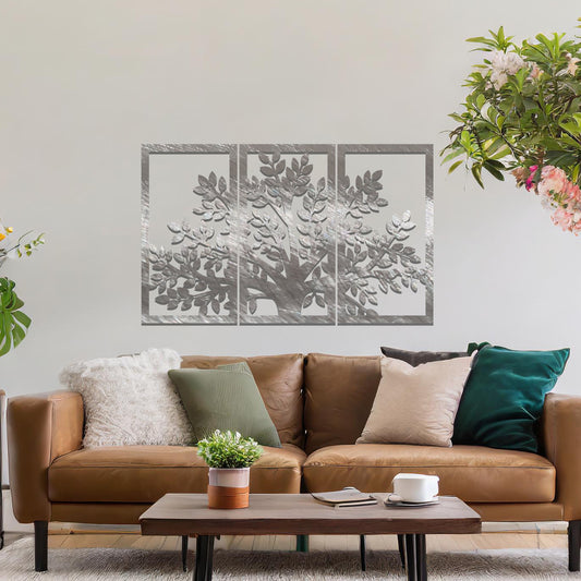 Metal wall art featuring a three-panel tree design with a detailed trunk, branches, and clustered leaves, crafted with precise laser-cut detailing, displayed on a neutral wall within modern decor.