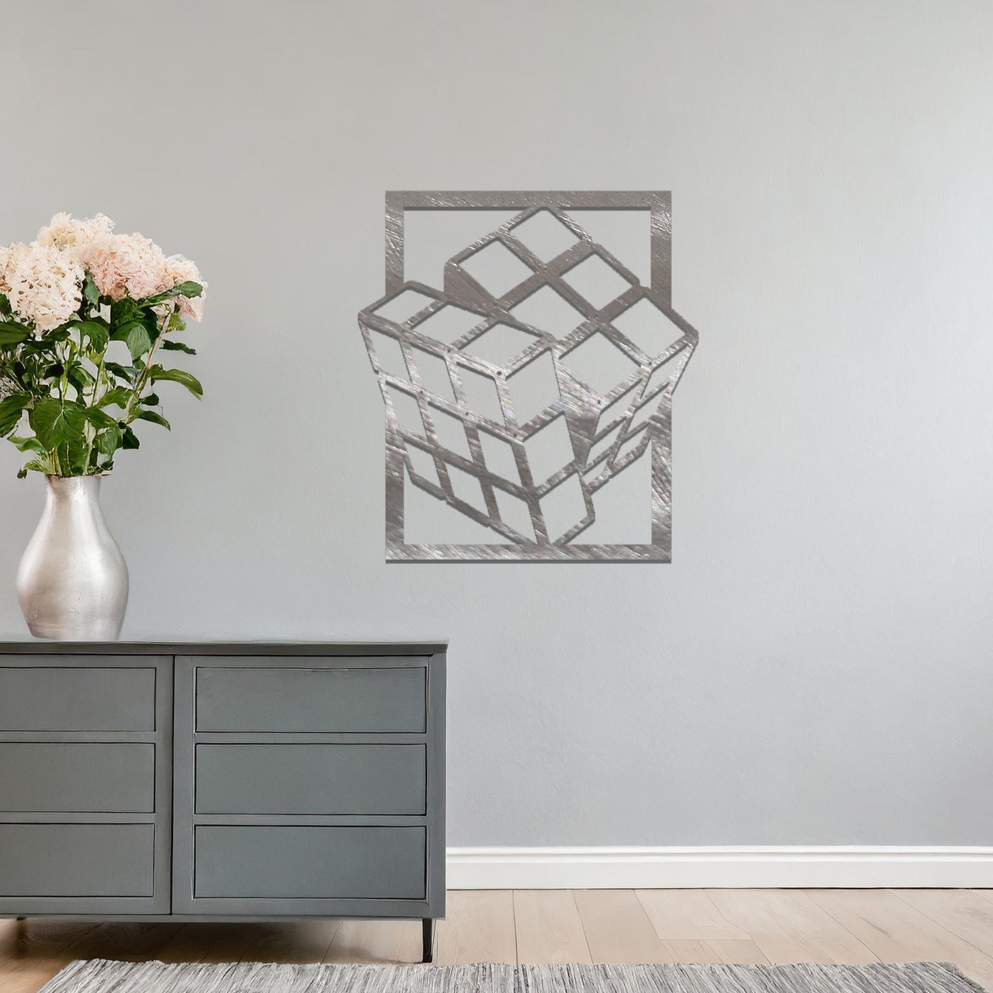 Metal wall art featuring a rectangular design of a three-dimensional cube, showcasing bold geometric shapes and a modern aesthetic as a statement piece.