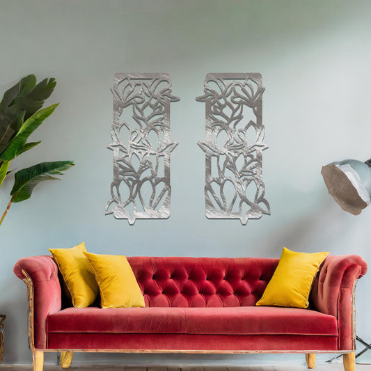 Metal wall art featuring a pair of vertical panels with floral-inspired designs of intertwined stems and leaves, crafted with precise laser-cut detailing, displayed on a neutral wall within modern decor.