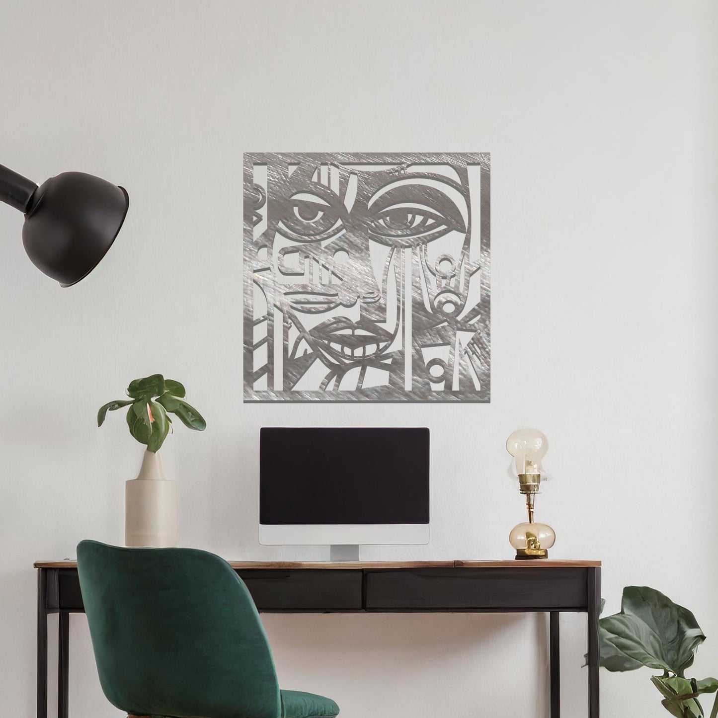 A metal wall art design featuring an abstract face with geometric shapes and sharp lines. The face's features are creatively outlined with strong contrasts, adding a modern, artistic touch to the space. The piece is displayed on a neutral wall, enhancing the room’s decor.