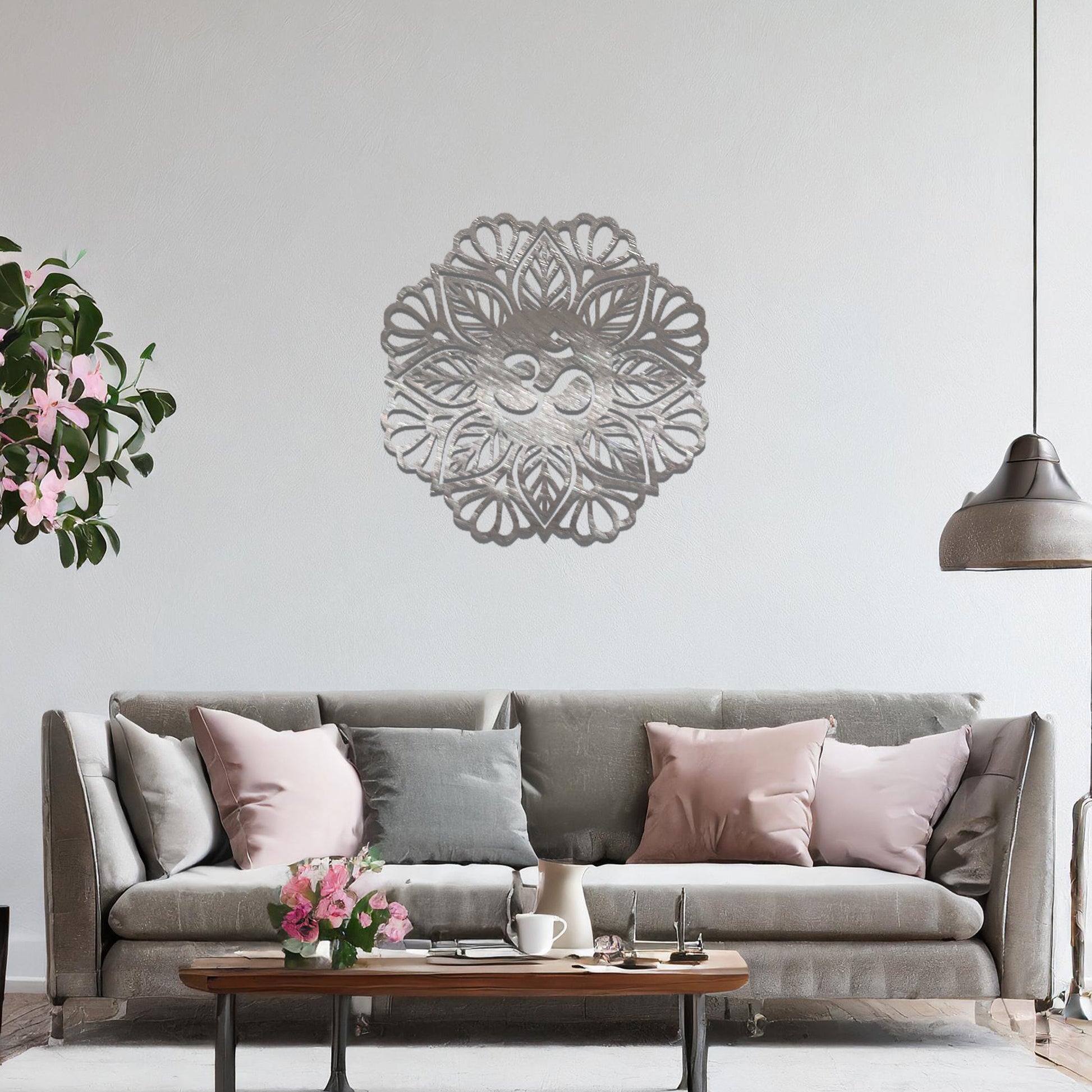Metal wall art featuring an intricate mandala design with the Om symbol at its center, mounted on a neutral wall within modern decor. The spiritual motif and detailed craftsmanship create a calming and elegant focal point.