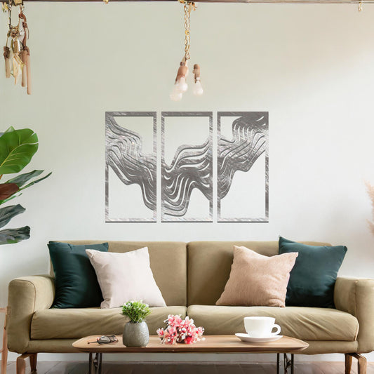 Metal wall art set of three panels featuring flowing, wave-like patterns. The design flows across the panels with a smooth, dynamic movement. The art is placed on a neutral wall in a modern living room, enhancing the space with a sleek, contemporary feel.