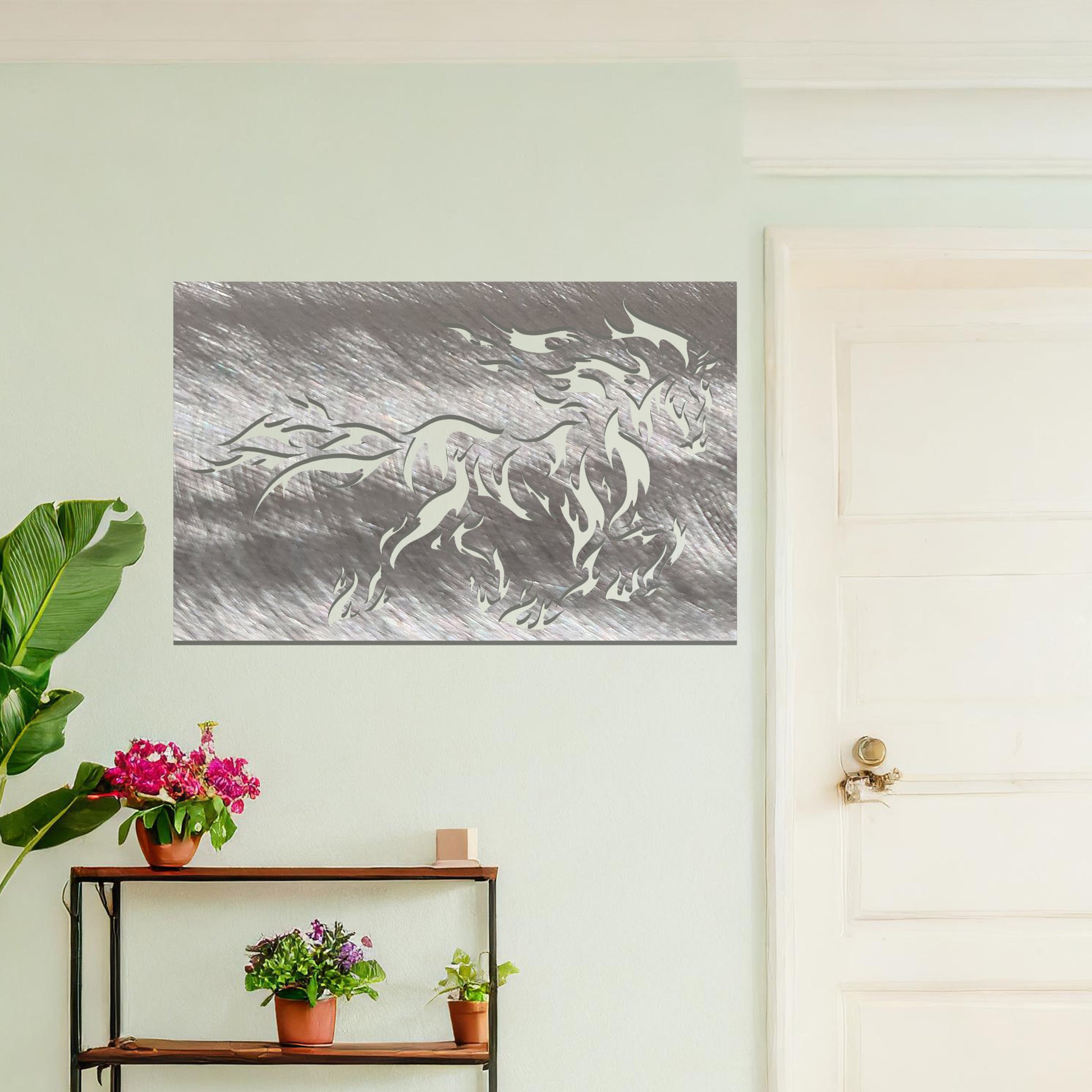 A metal wall art design featuring a powerful horse in motion, with flames integrated into its mane and tail, creating a dynamic and dramatic effect. The artwork is displayed on a neutral wall within a modern setting, enhancing the space's bold, stylish look.