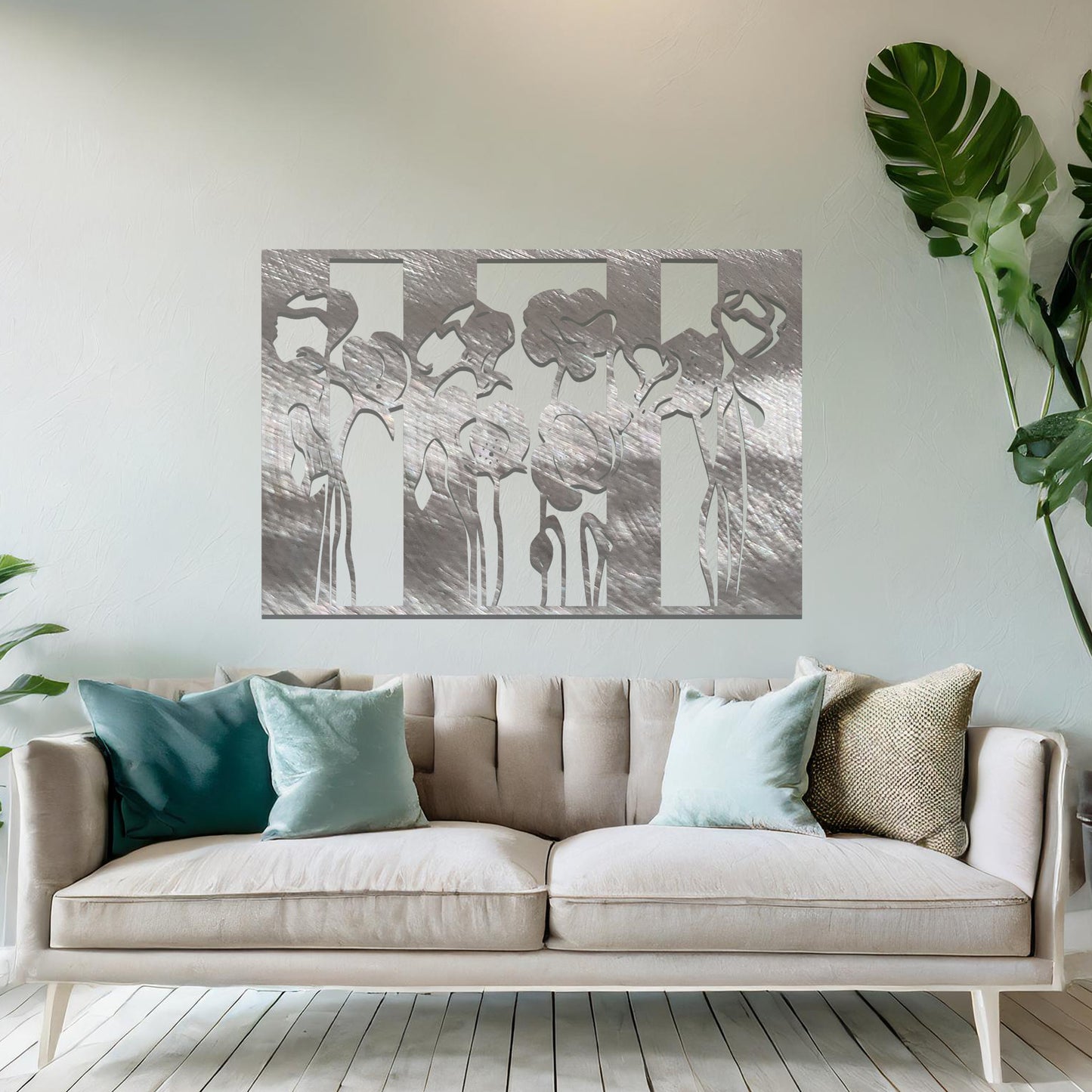 A metal wall art design featuring stylized flowers with long, elegant stems, arranged vertically in a series of three sections. The art is displayed on a neutral wall within a modern room decor, adding a contemporary and artistic touch to the space.