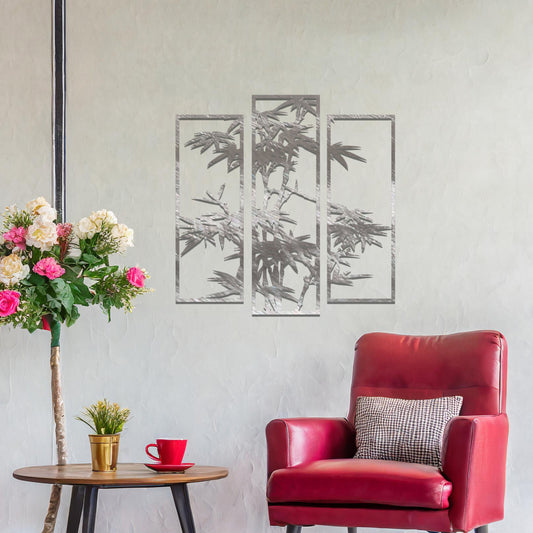 Metal wall art featuring a three-panel bamboo design with intricate leaves and stems, crafted with precise laser-cut detailing, displayed on a neutral wall within modern decor.