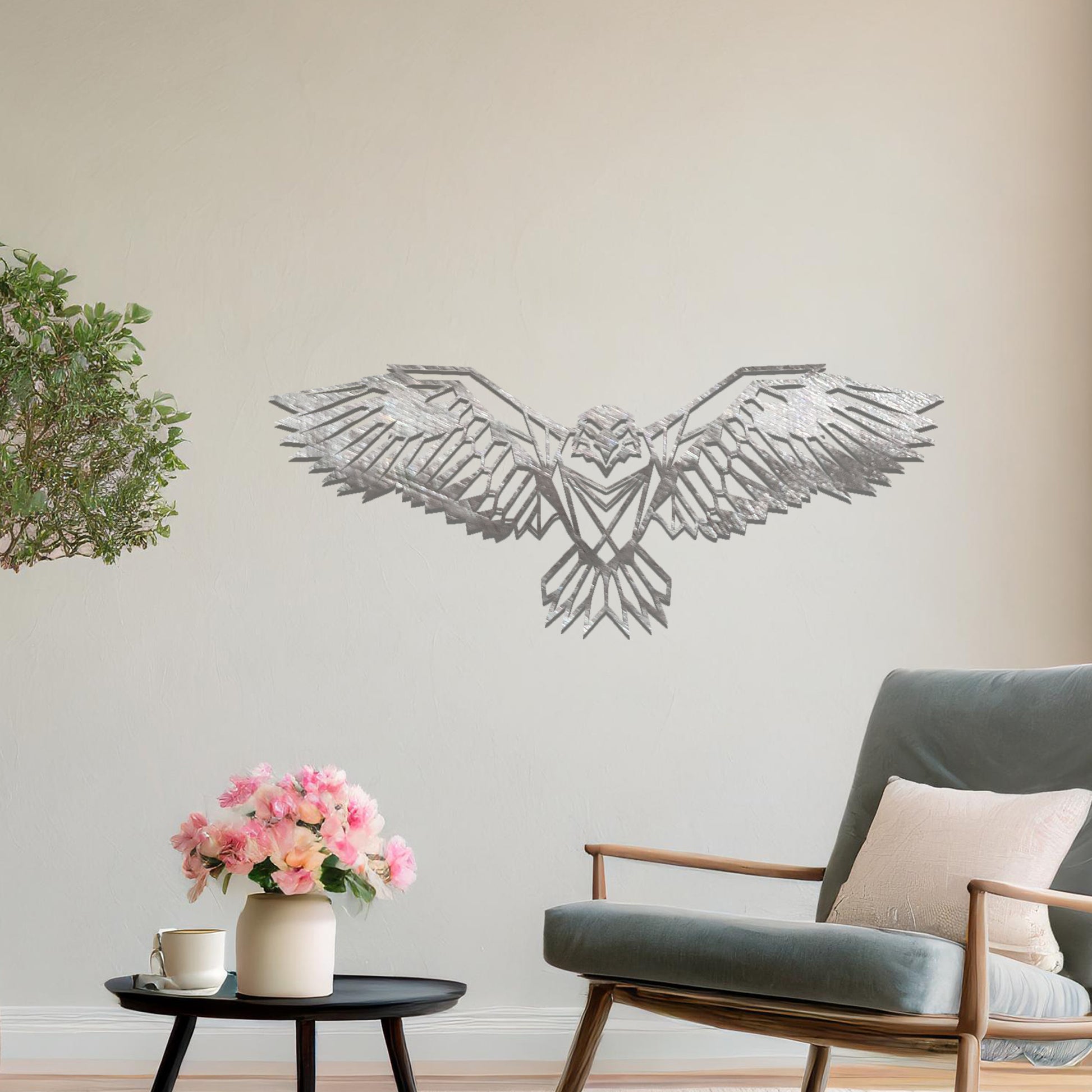 Metal wall art featuring a geometric eagle design with outstretched wings and intricate detailing, crafted with precise laser-cut techniques, displayed on a neutral wall within modern decor.