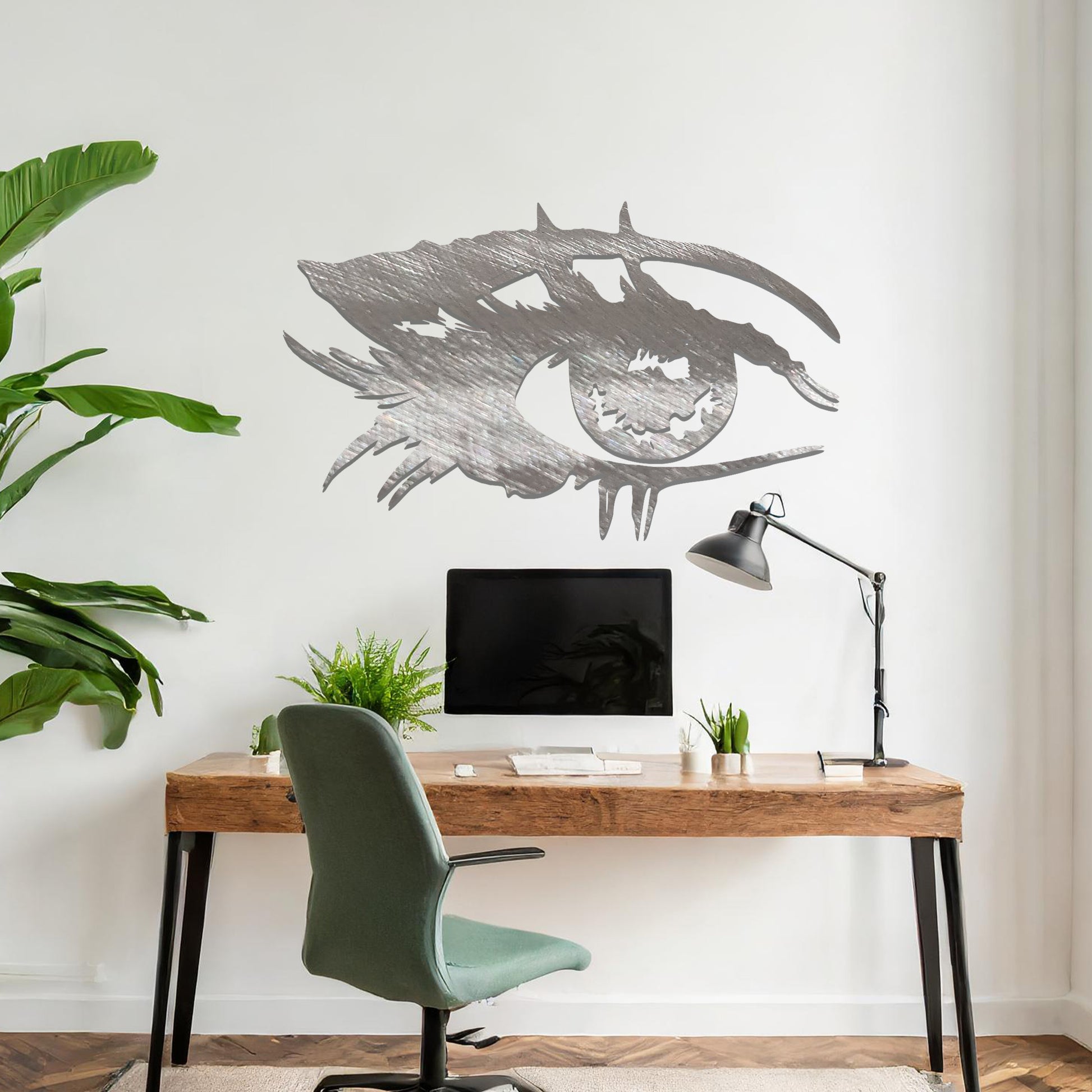 Striking metal wall art featuring a bold and artistic eye design with intricate detailing, mounted on a neutral wall within modern room decor. The focus is entirely on the creative and contemporary craftsmanship of the wall art, enhancing the space's aesthetic appeal.