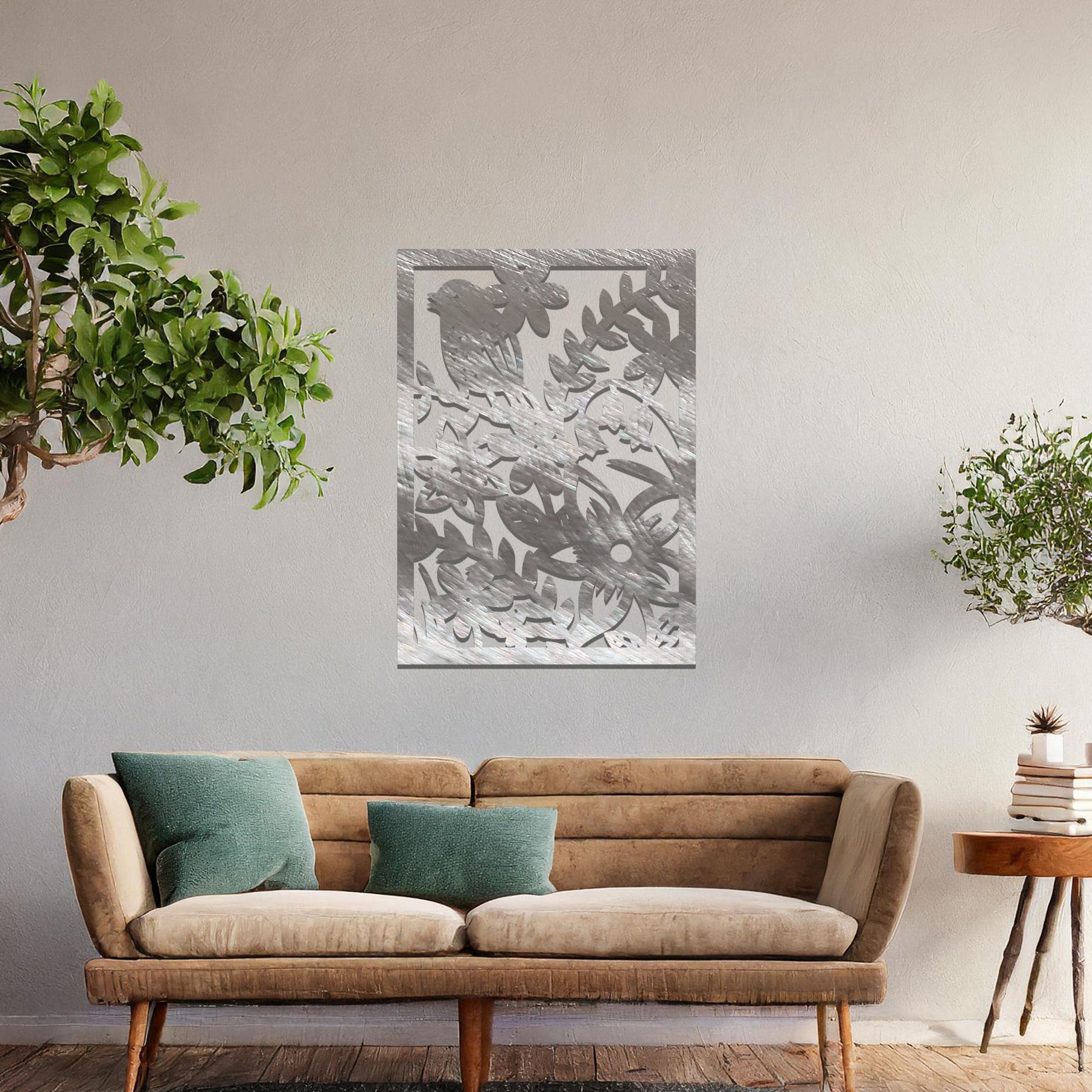 Metal wall art featuring a rectangular design with a bird perched amidst detailed floral and leafy patterns, mounted on a neutral wall within modern room decor. The intricate details and natural elements create a lively and elegant focal point.