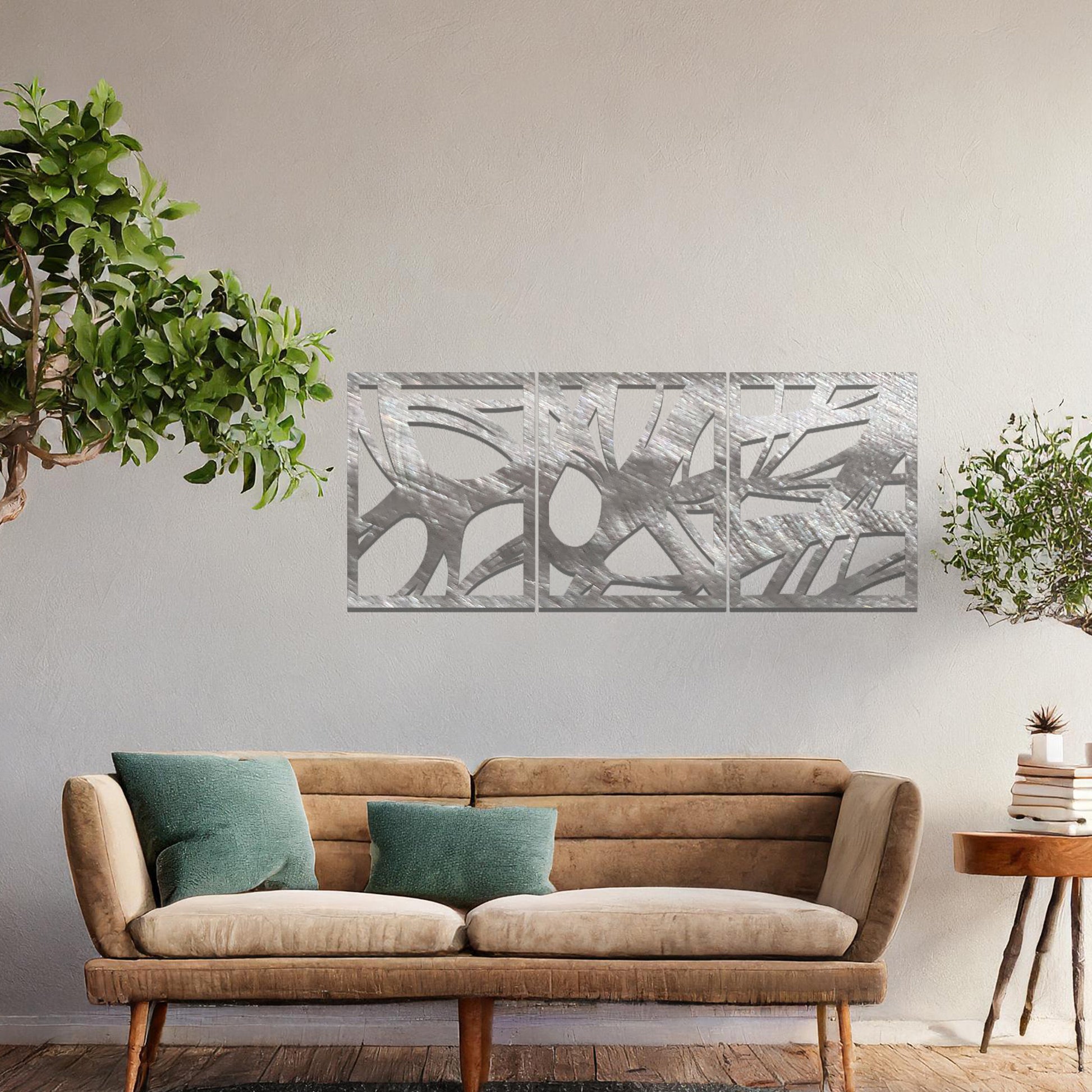 Metal wall art featuring a three-panel design with abstract organic shapes, mounted on a neutral wall within modern decor. The rust finish and fluid, nature-inspired forms create a striking focal point, enhancing the room’s natural aesthetic.